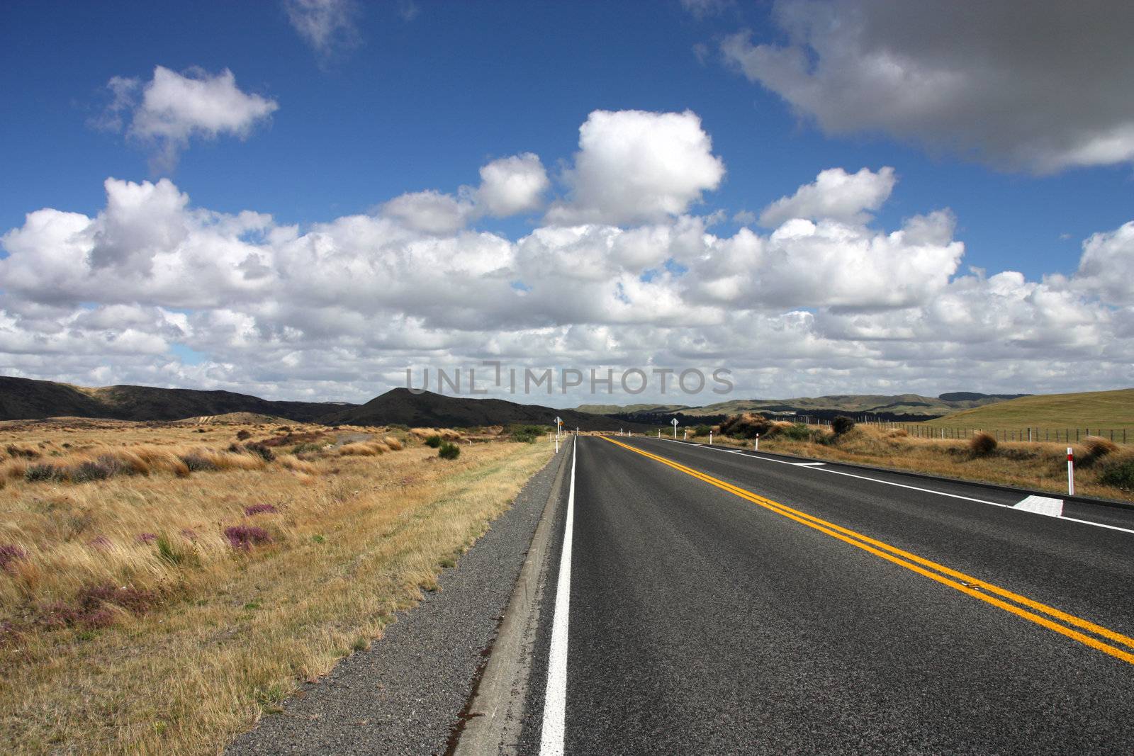 Straight road and beautiful clouds in New Zealand - North Island