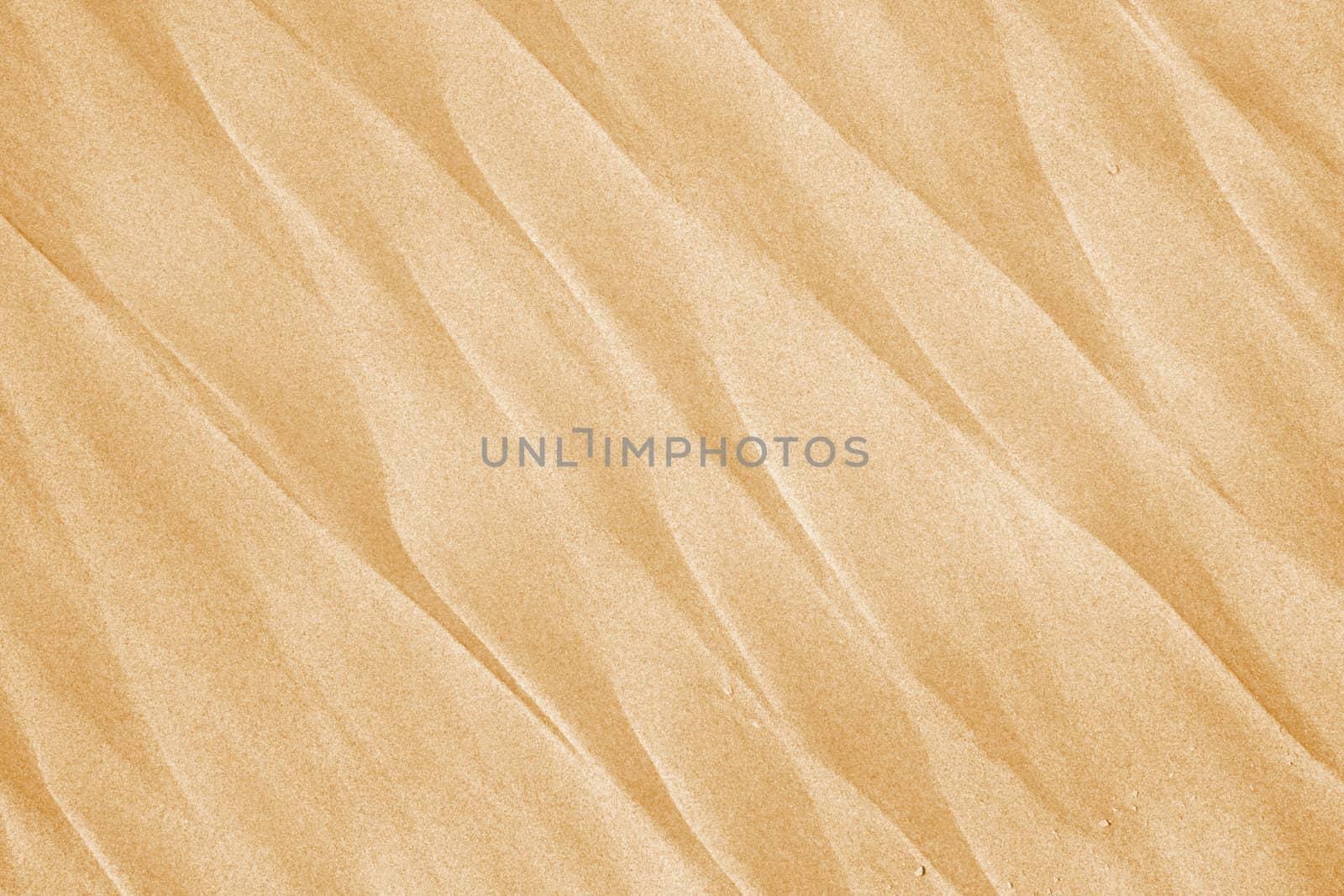 Sand waves - beautiful beach background. Abstract orange texture.