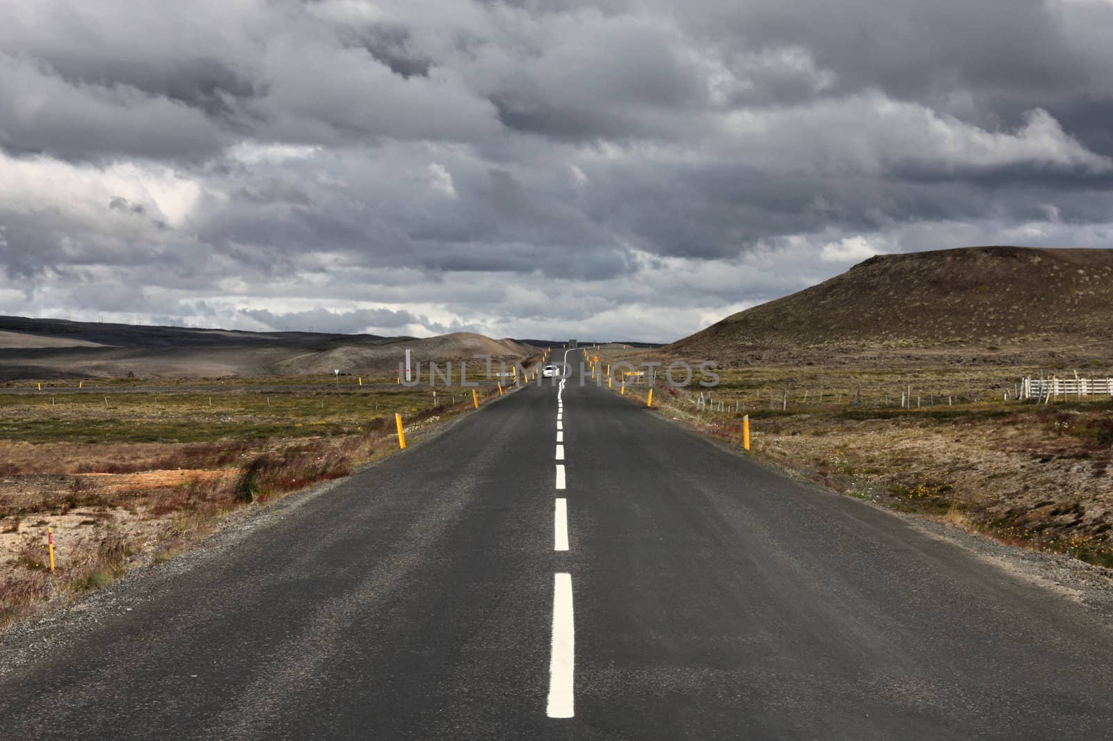 Straight road in Iceland. Volcanic area of Krafla. Vanishing point.