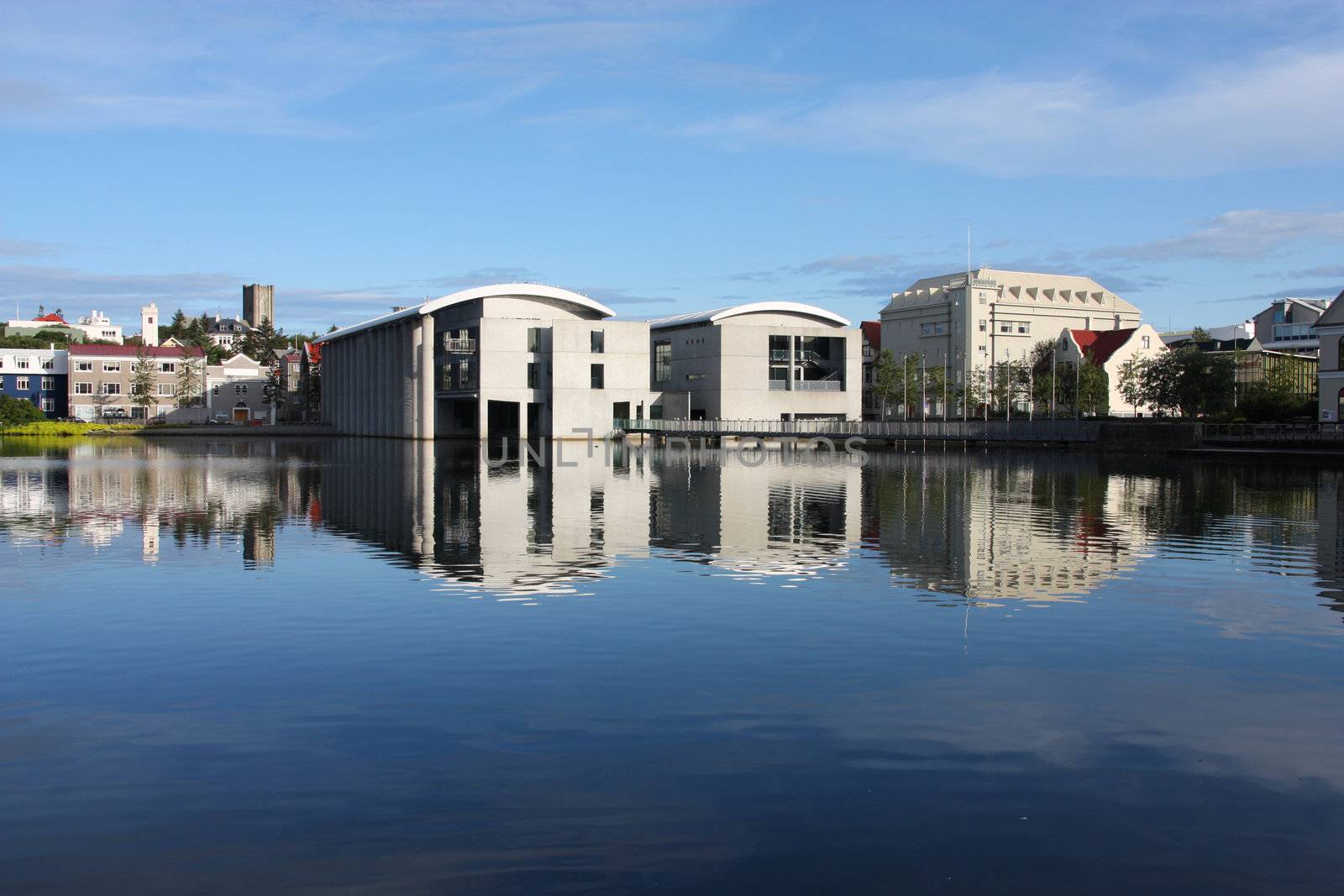 City Hall in Reykjavik, Iceland. Lake Tjorning reflection. Modern architecture.