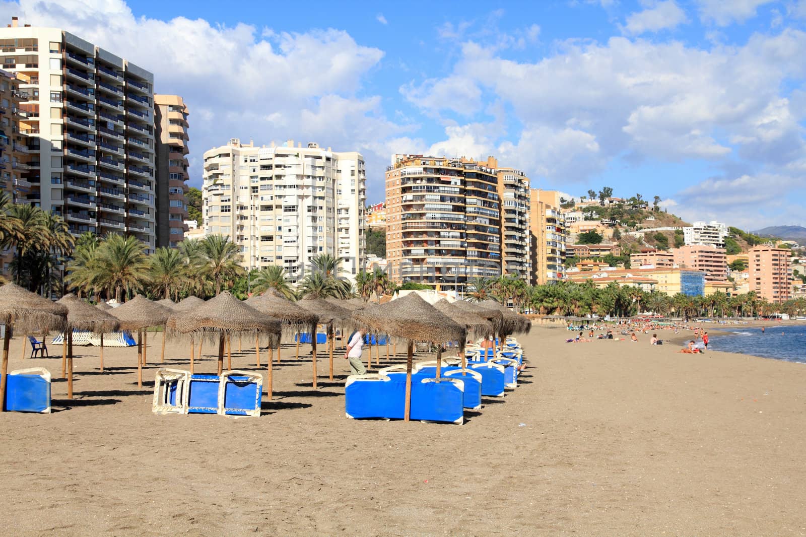 Malaga in Andalusia region of Spain. Suntanning chairs on a sandy beach.