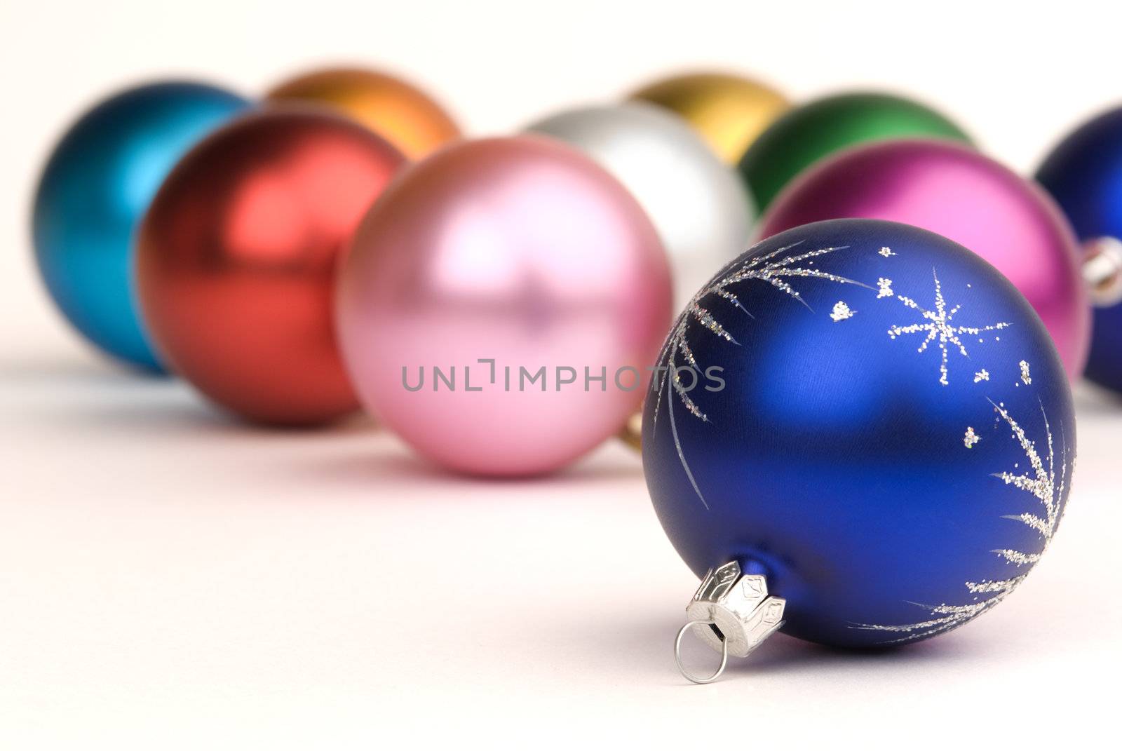 christmas decorations on white background( focus point on nearest ball (metal part))