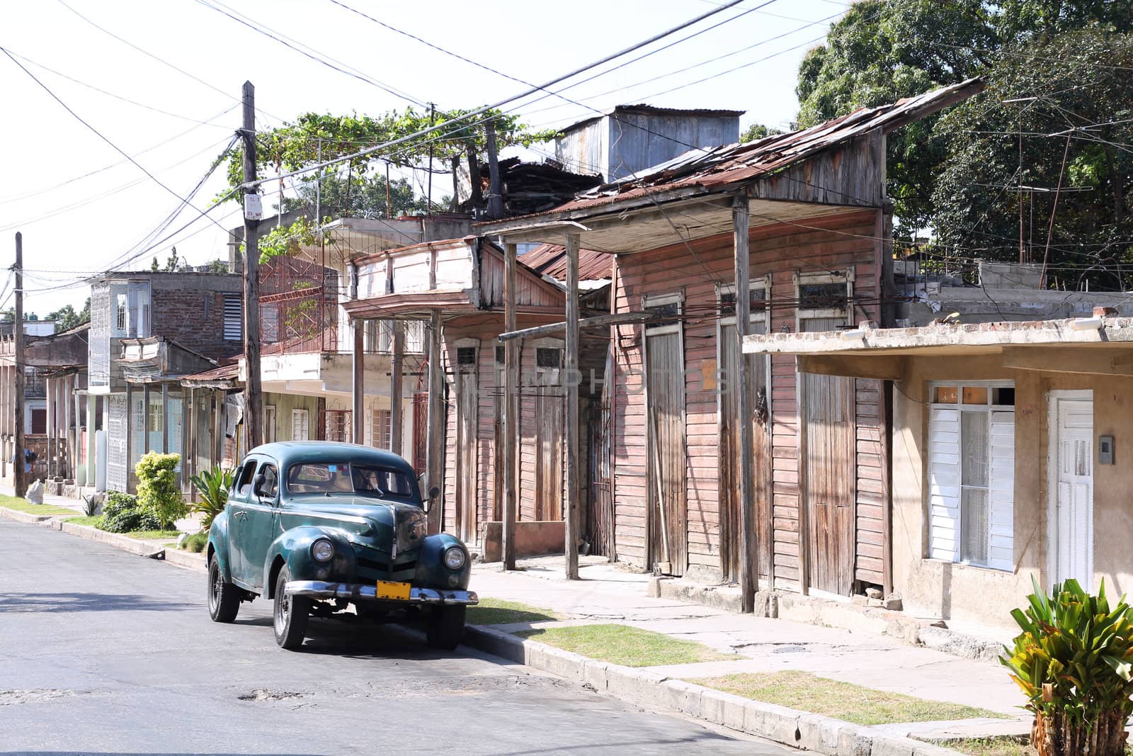 Santiago de Cuba - street view with a classic American car parked