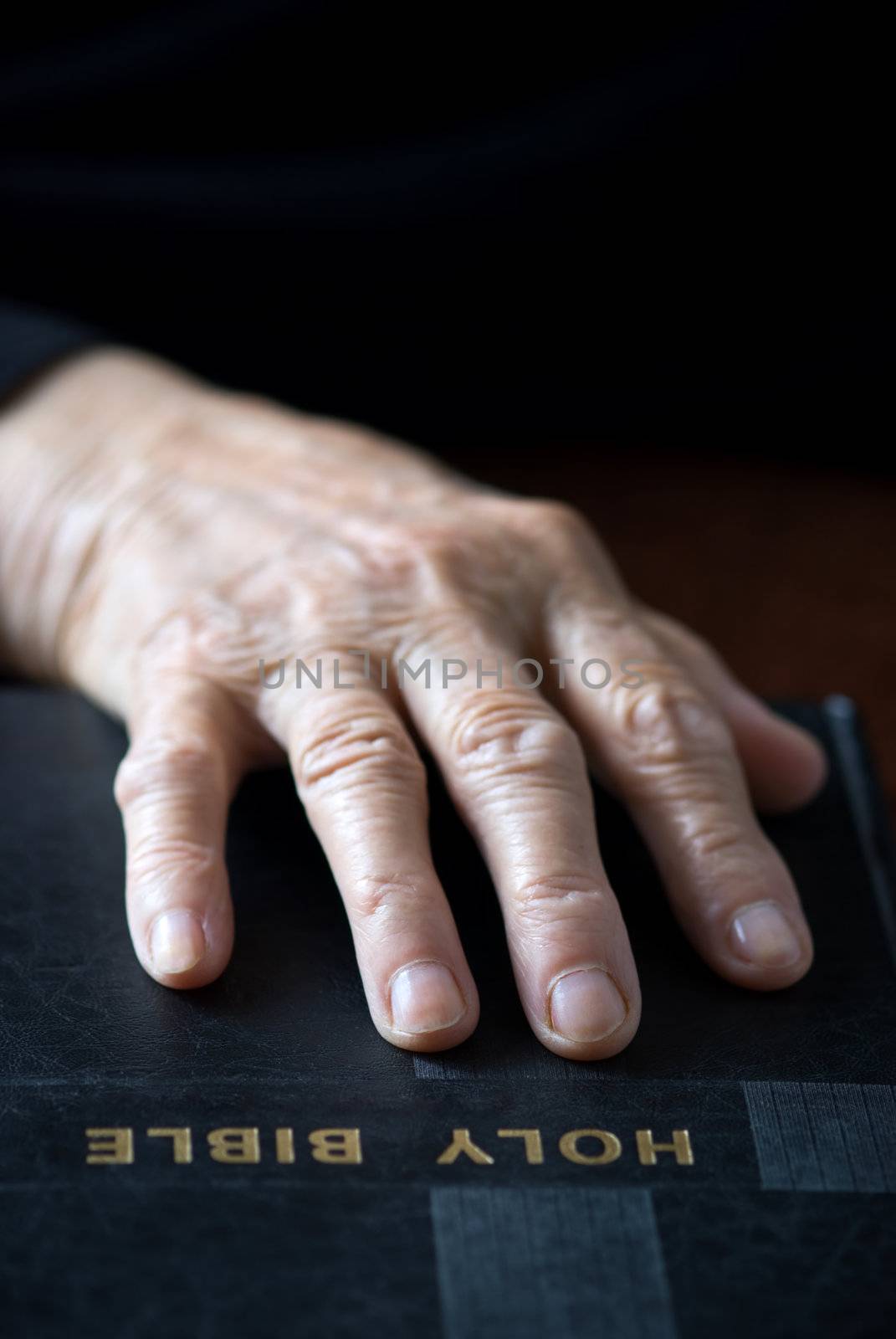 hand on the Bible (focus point on fingers,selective)