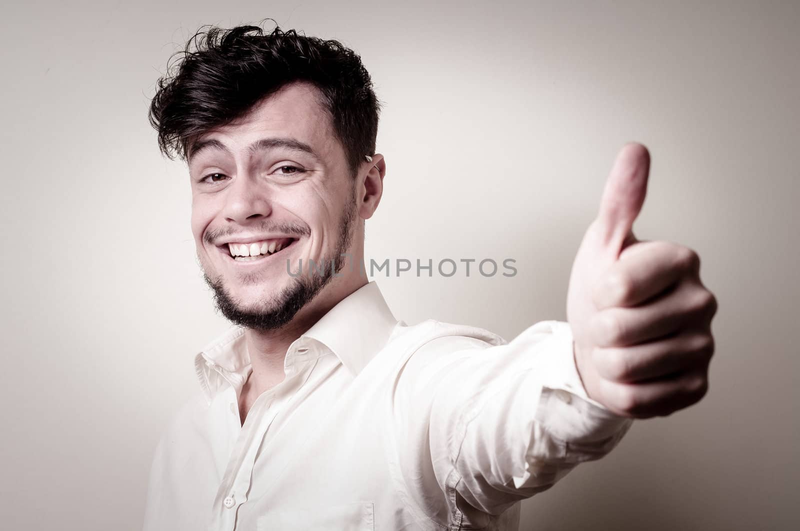 stylish modern guy with white shirt on gray background