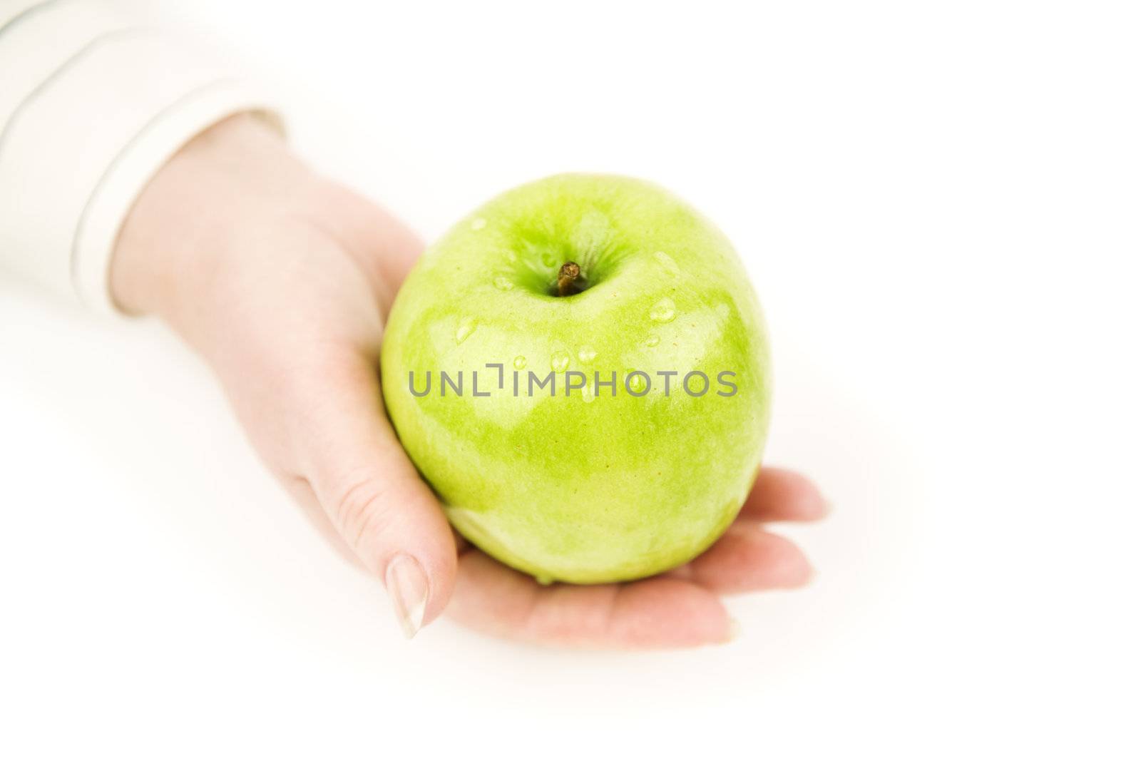 isolated hand with apple,focus point on drops of green apple