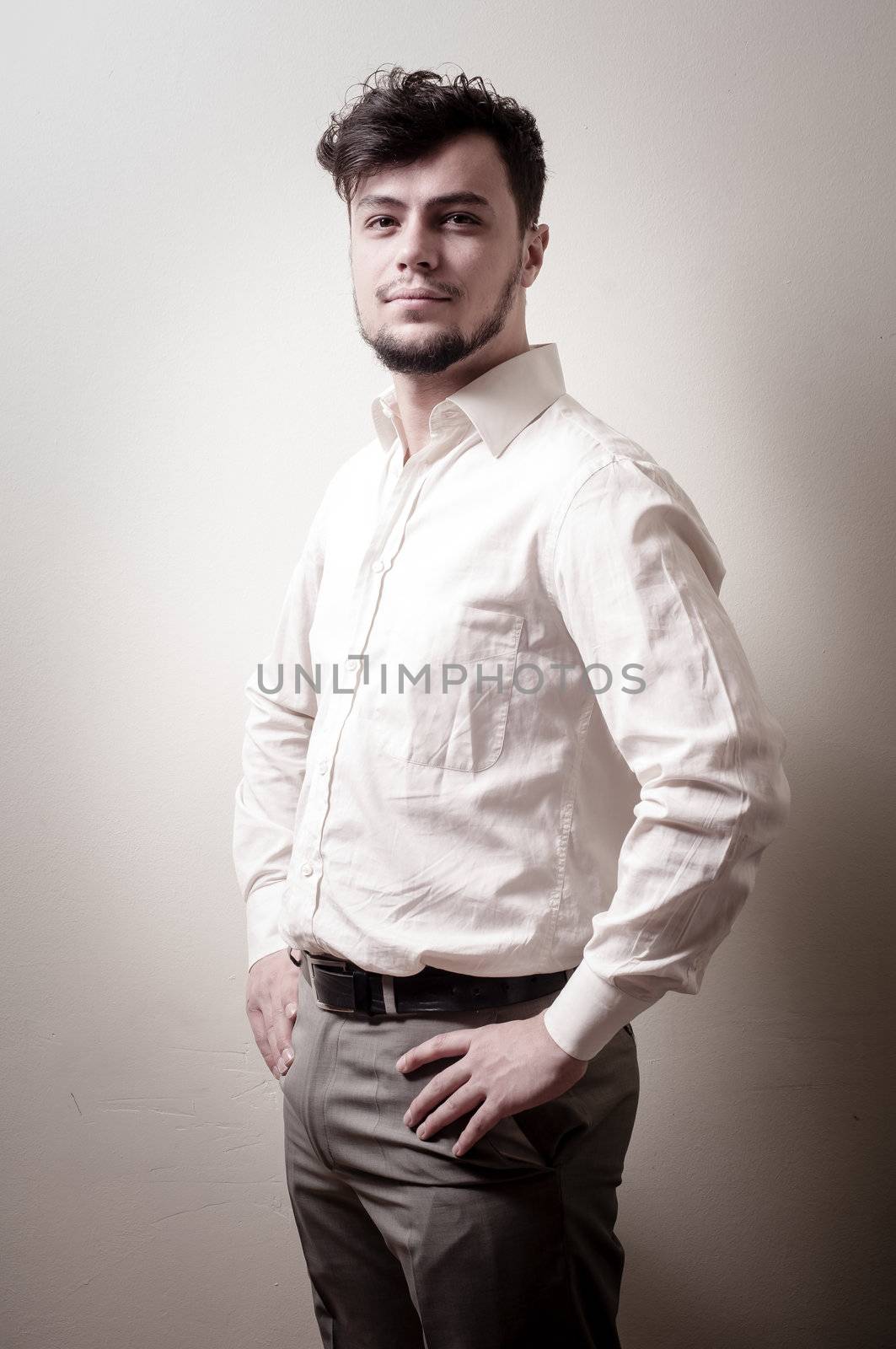 stylish modern guy with white shirt on gray background