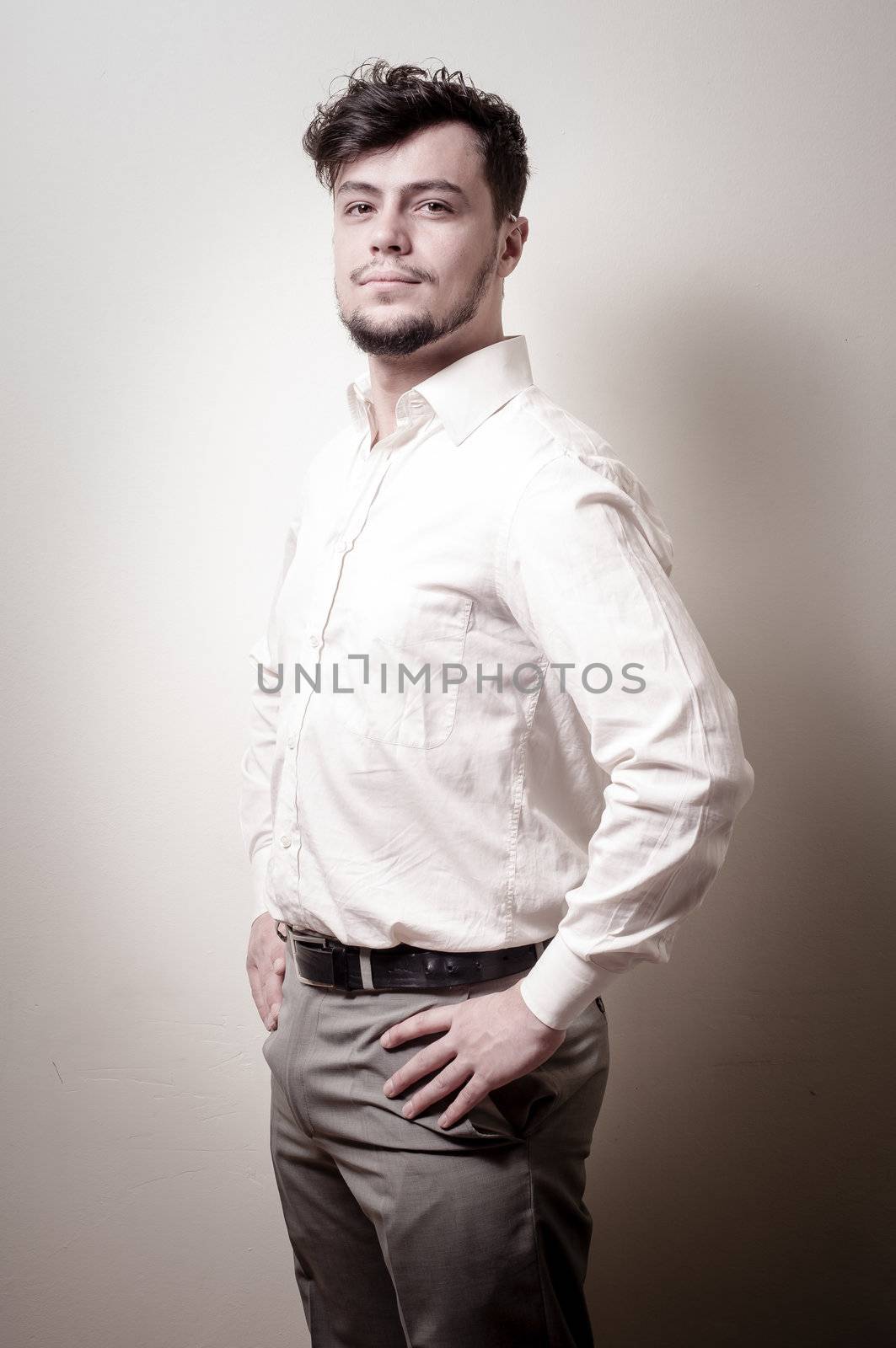 stylish modern guy with white shirt on gray background