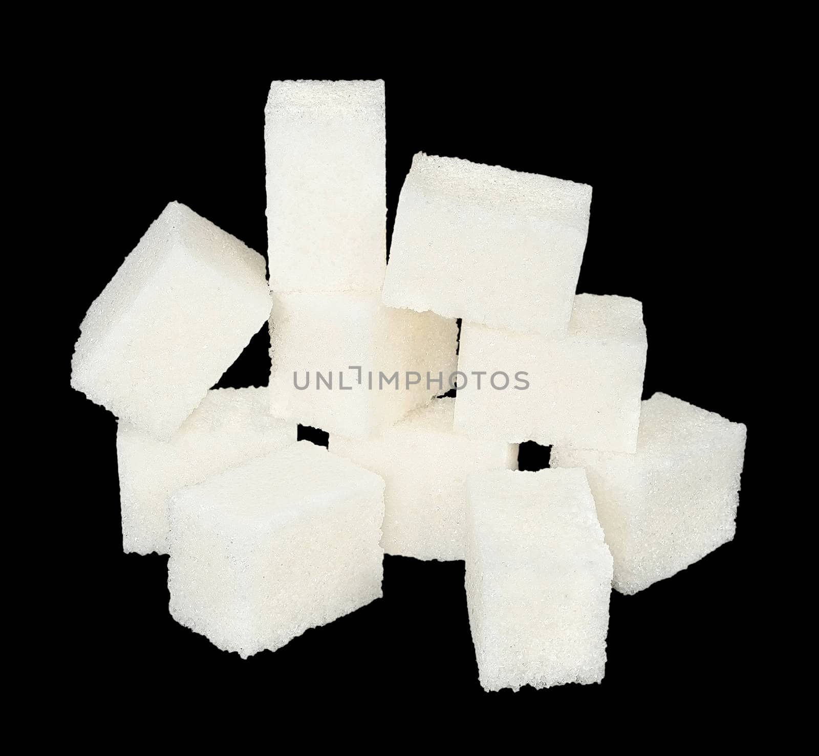 Pieces of sugar on a black background.