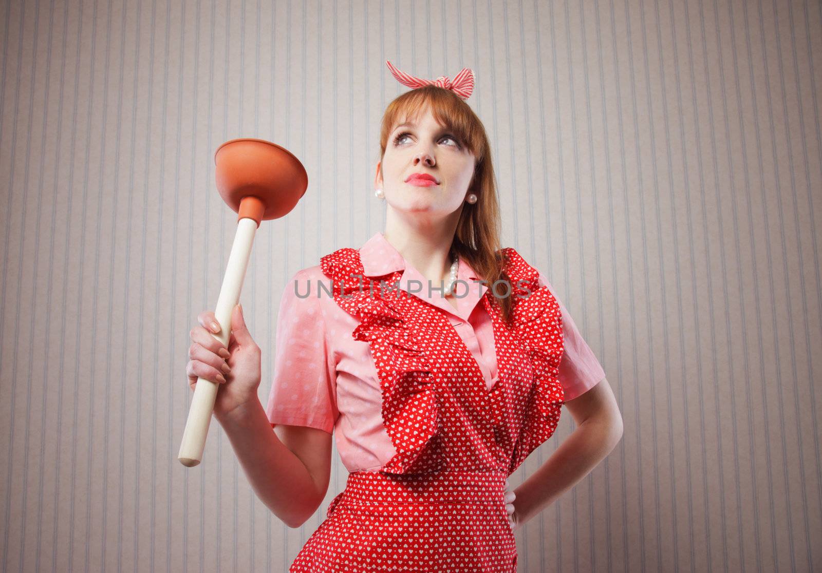 Retro housewife with tool to clean toilettes