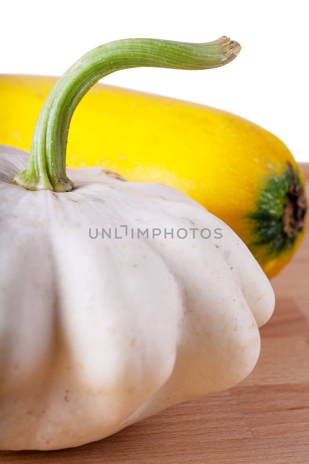 Pattypan and marrow vegetables on a wooden table