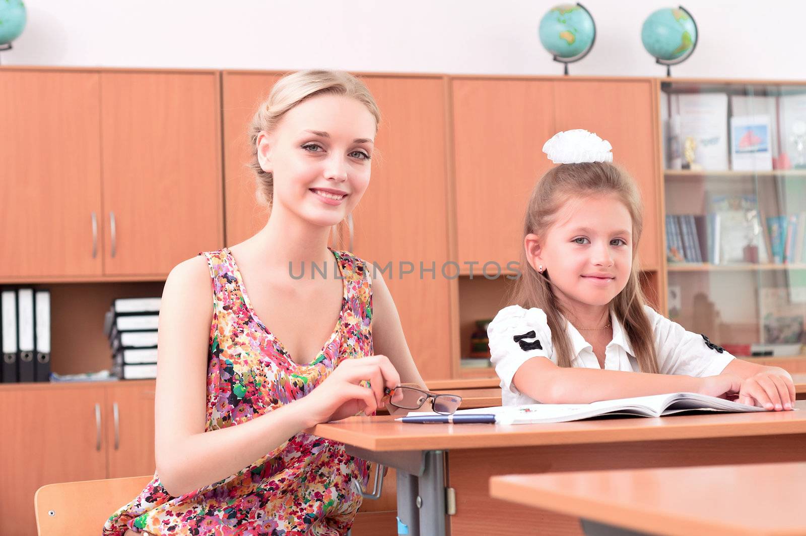 teacher sitting near pupil by adam121