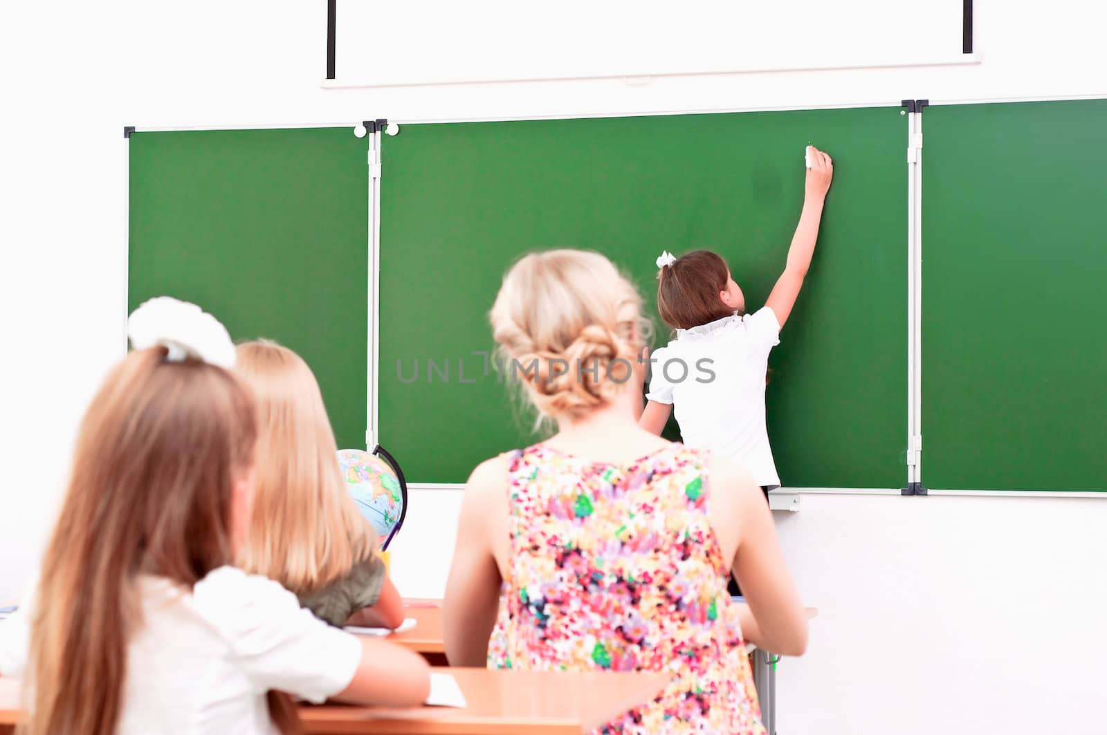 school girl writes on the blackboard by adam121