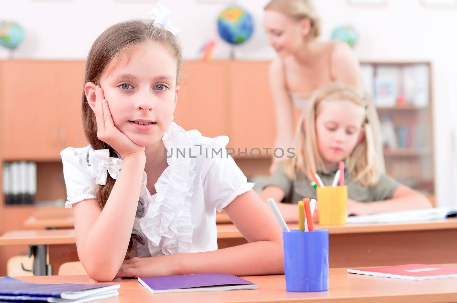 portrait of students in the classroom, sit at school desks