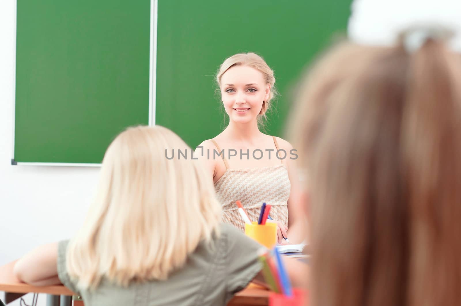 young teacher in the classroom by adam121