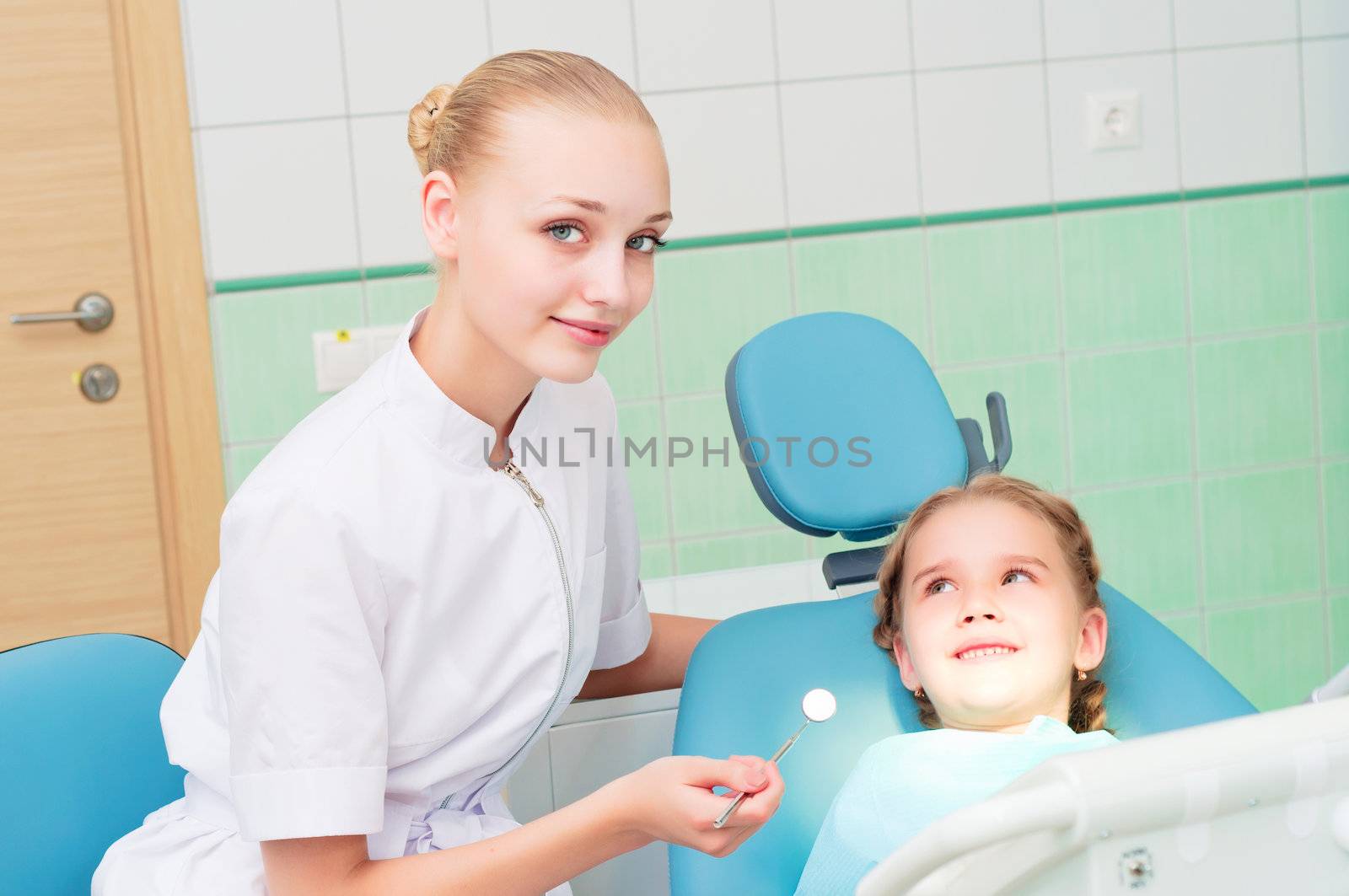 young doctor woman and girl in dentist office, regular visits to the dentist