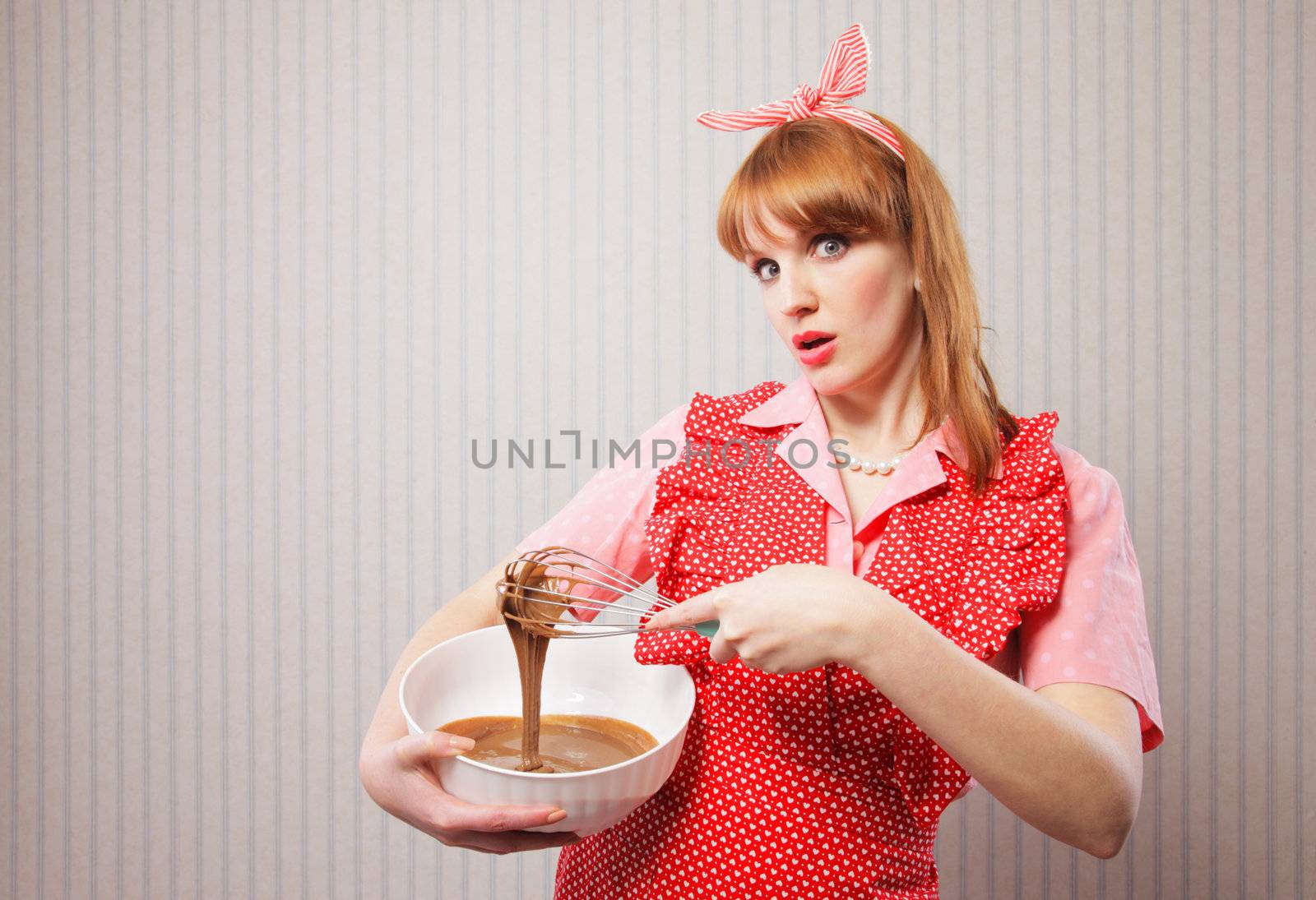 Stereotypical housewife, manual mixer and bowl, on wallpaper background