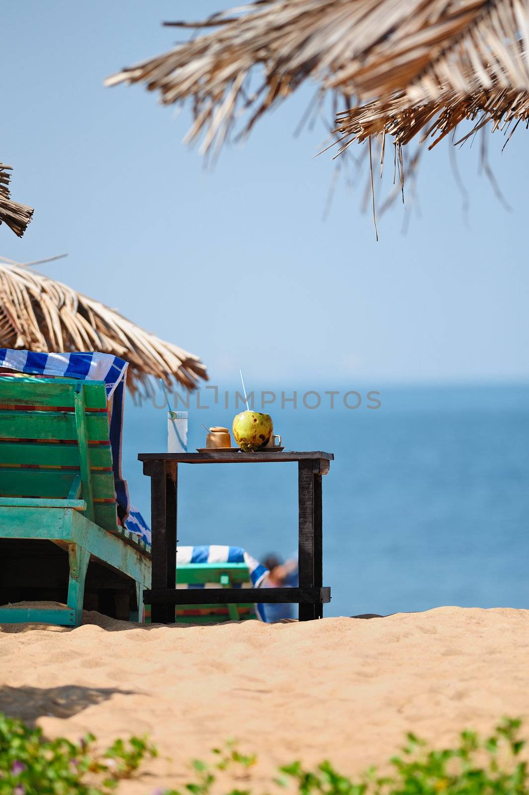Exotic beach umbrellas and chairs on tropical coast