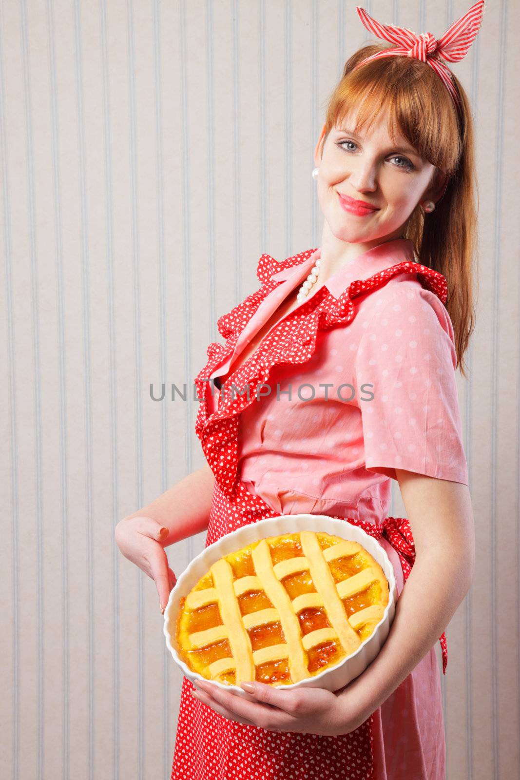 Retro housewife holding hot italian pie.