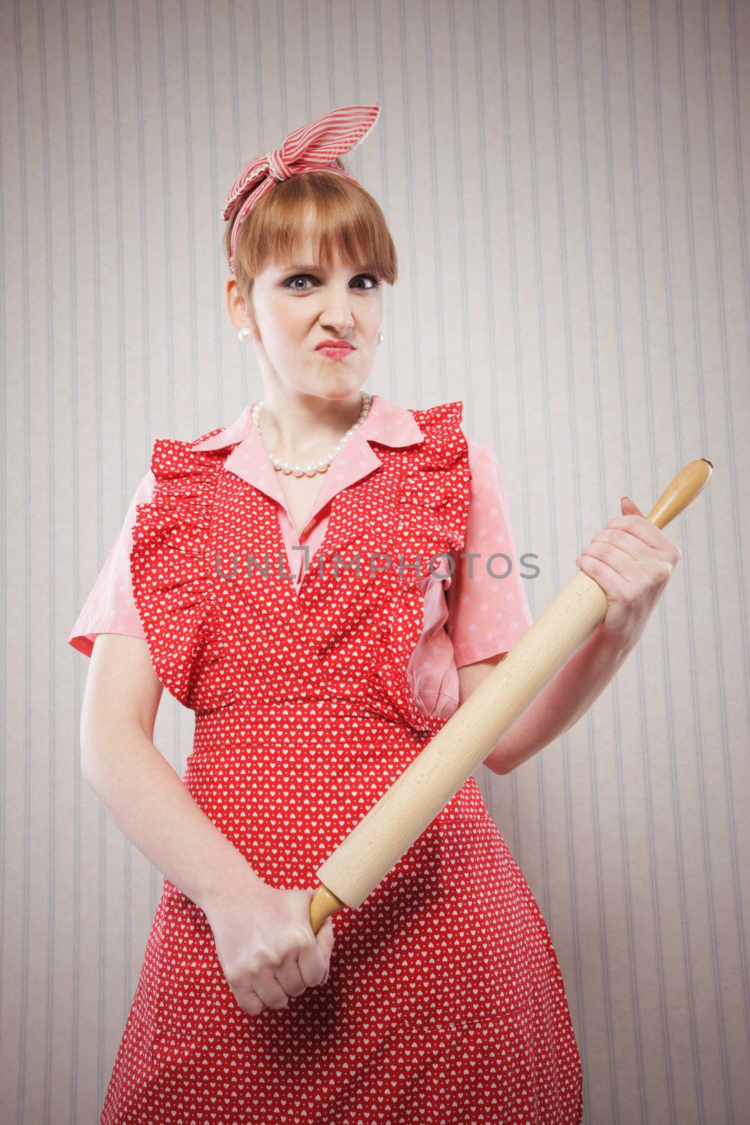 Angry housewife with rolling pin