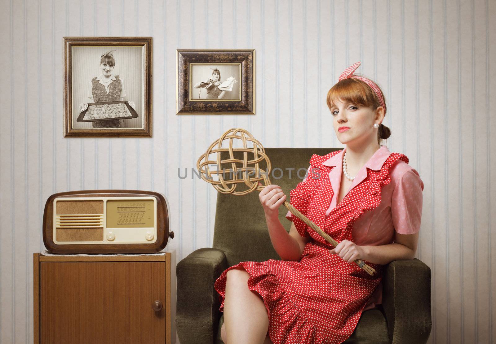 Ironic portrait of a housewife retro sitting in an armchair