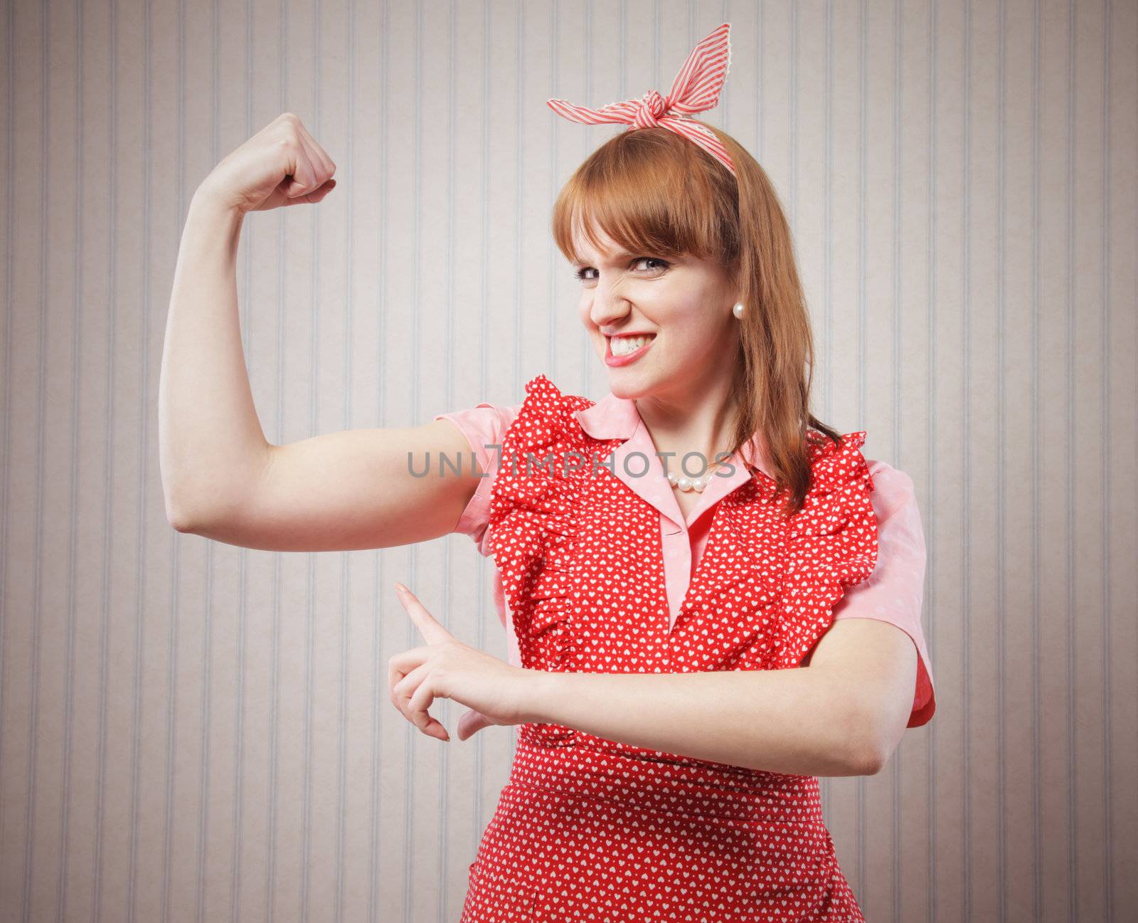 Strong woman housewife showing muscular strength