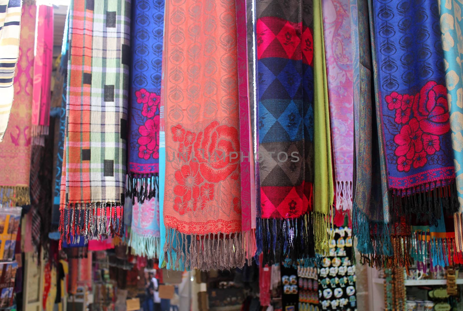 Colorful scarves at a market by irisphoto4