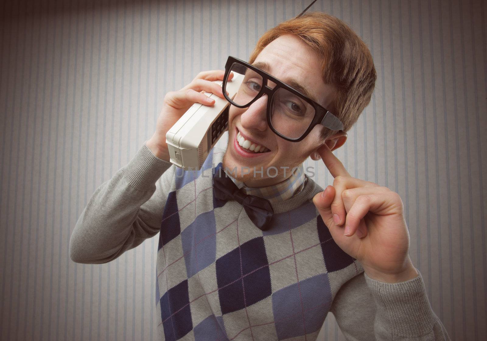 Nerd student with an old mobile phone
