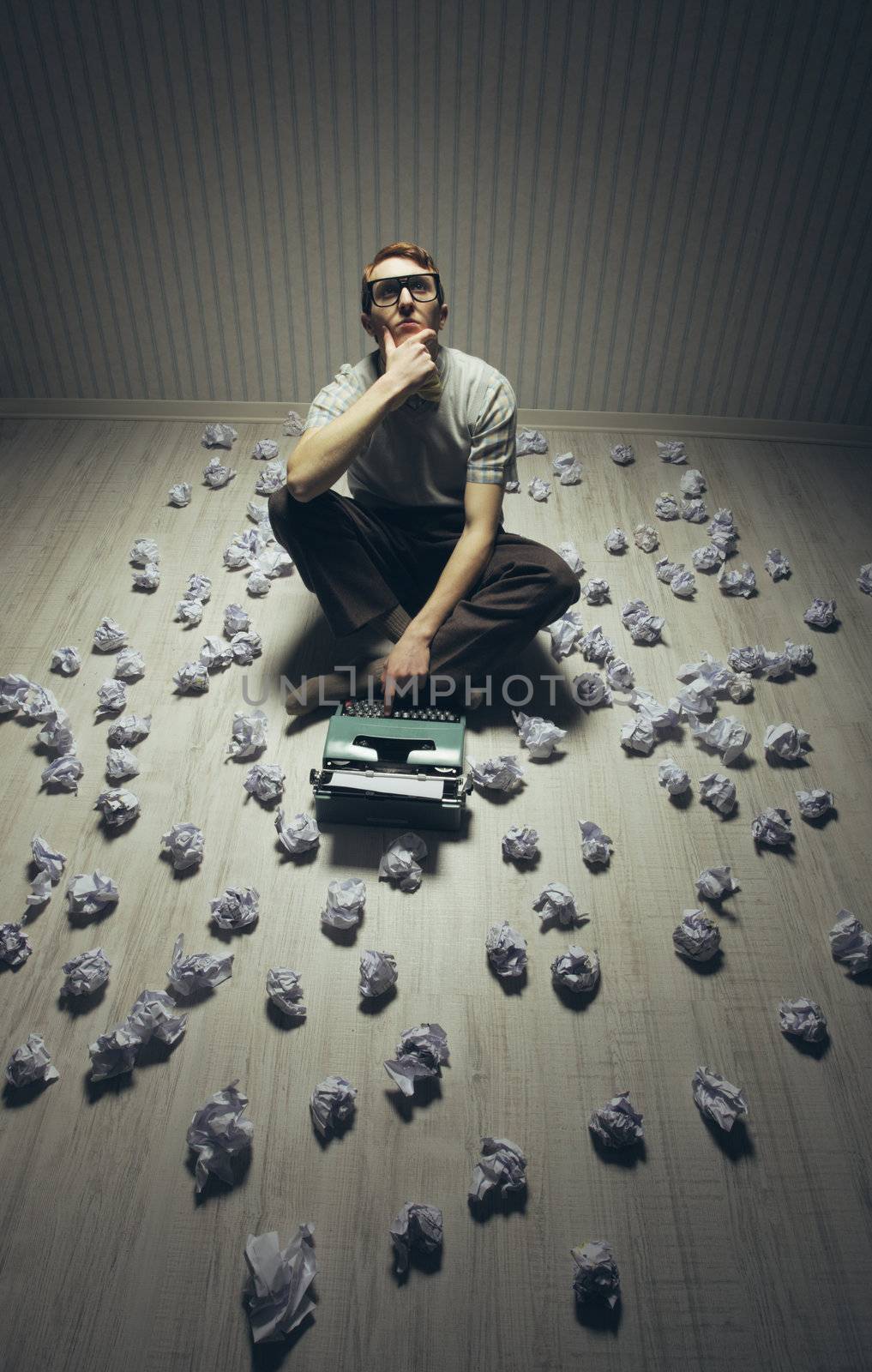Young writer searching inspiration, with an old typewriter.