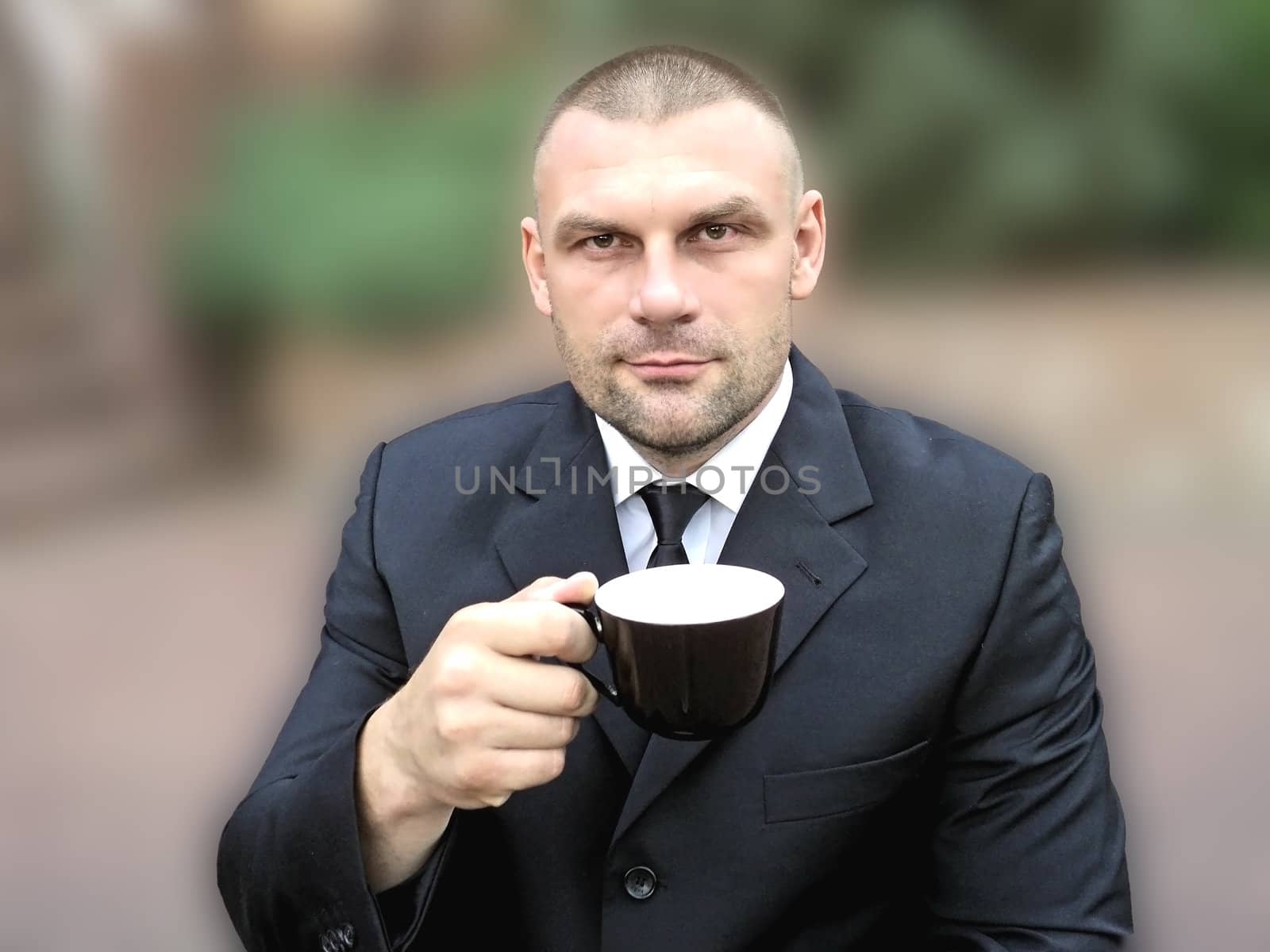 Middle-aged man with a cup in his hand on a soft background