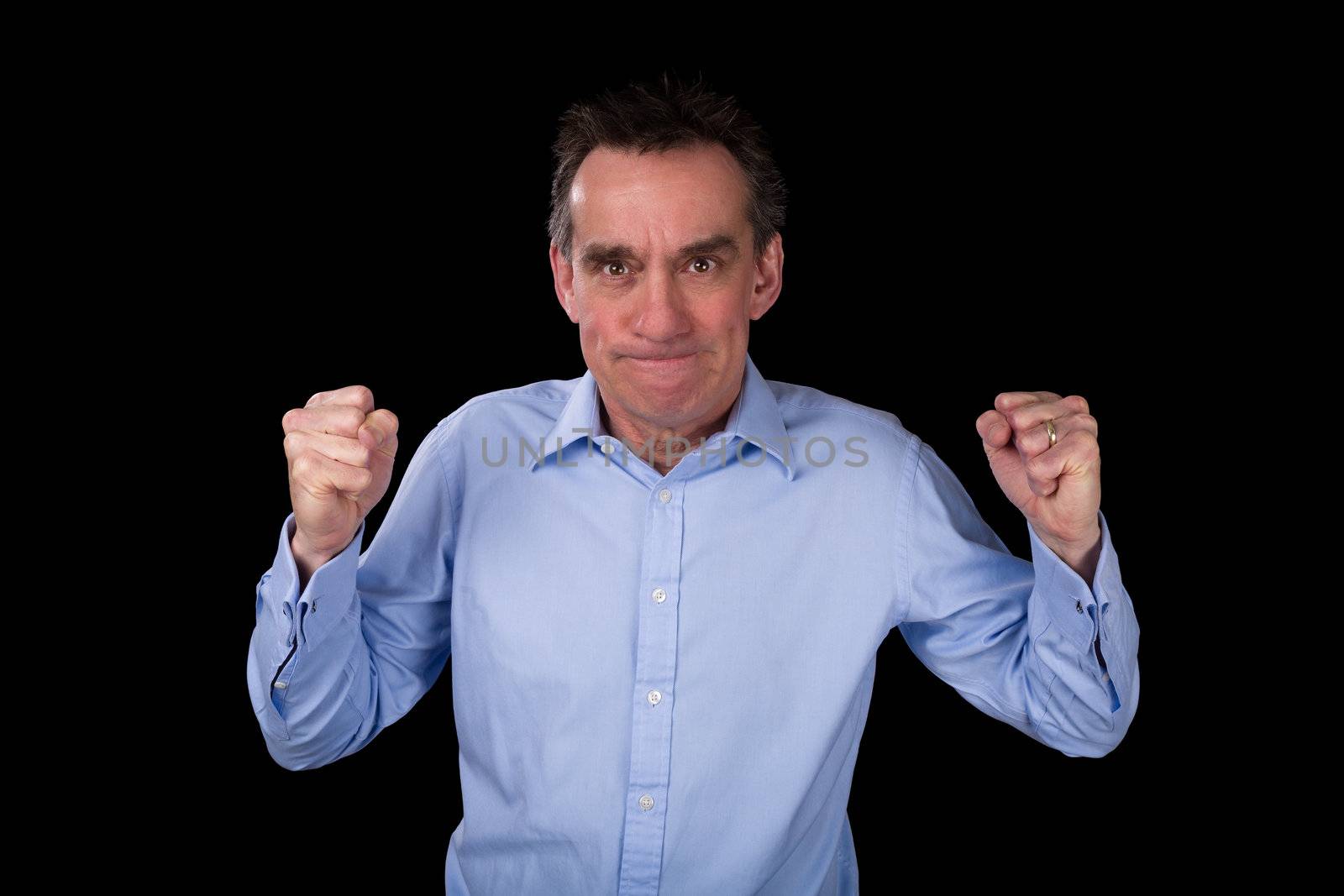 Angry Middle Age Business Man Shaking Fists in Frustration Black Background