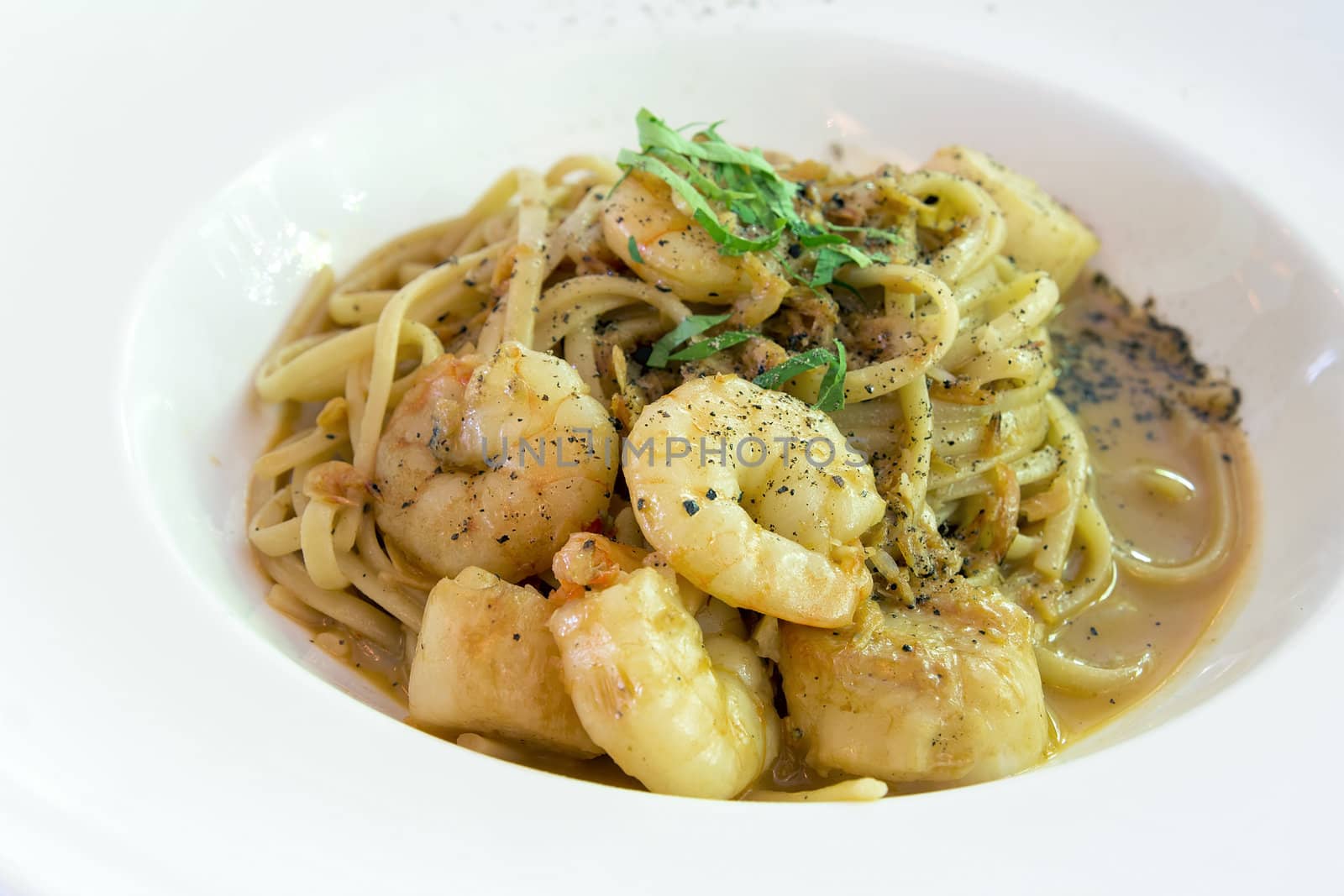 Linguini with Pan Seared Tiger Prawns and Scallops in a Bisque Cream Sauce Closeup