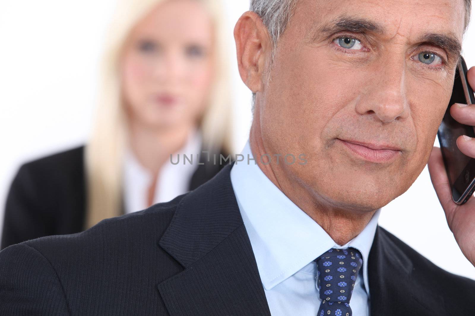 Older businessman using a cellphone