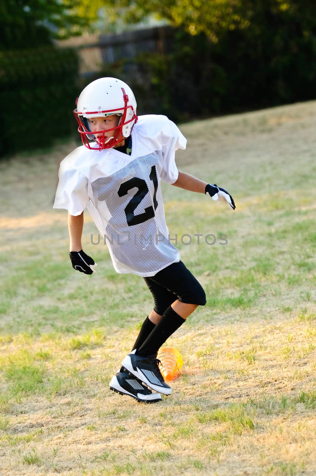 Yooung football player looking for a pass.