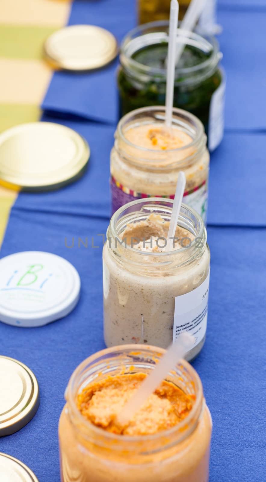 A lot of soup jars on a blue table