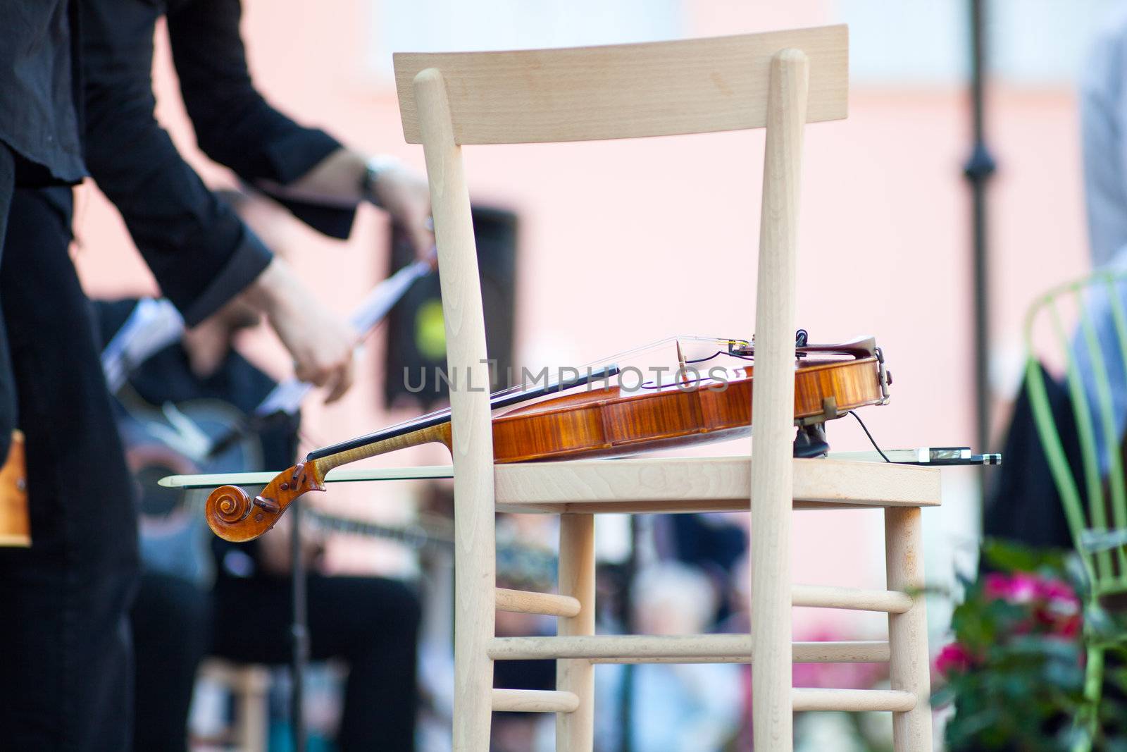 Violin on a wooden chair before the concert