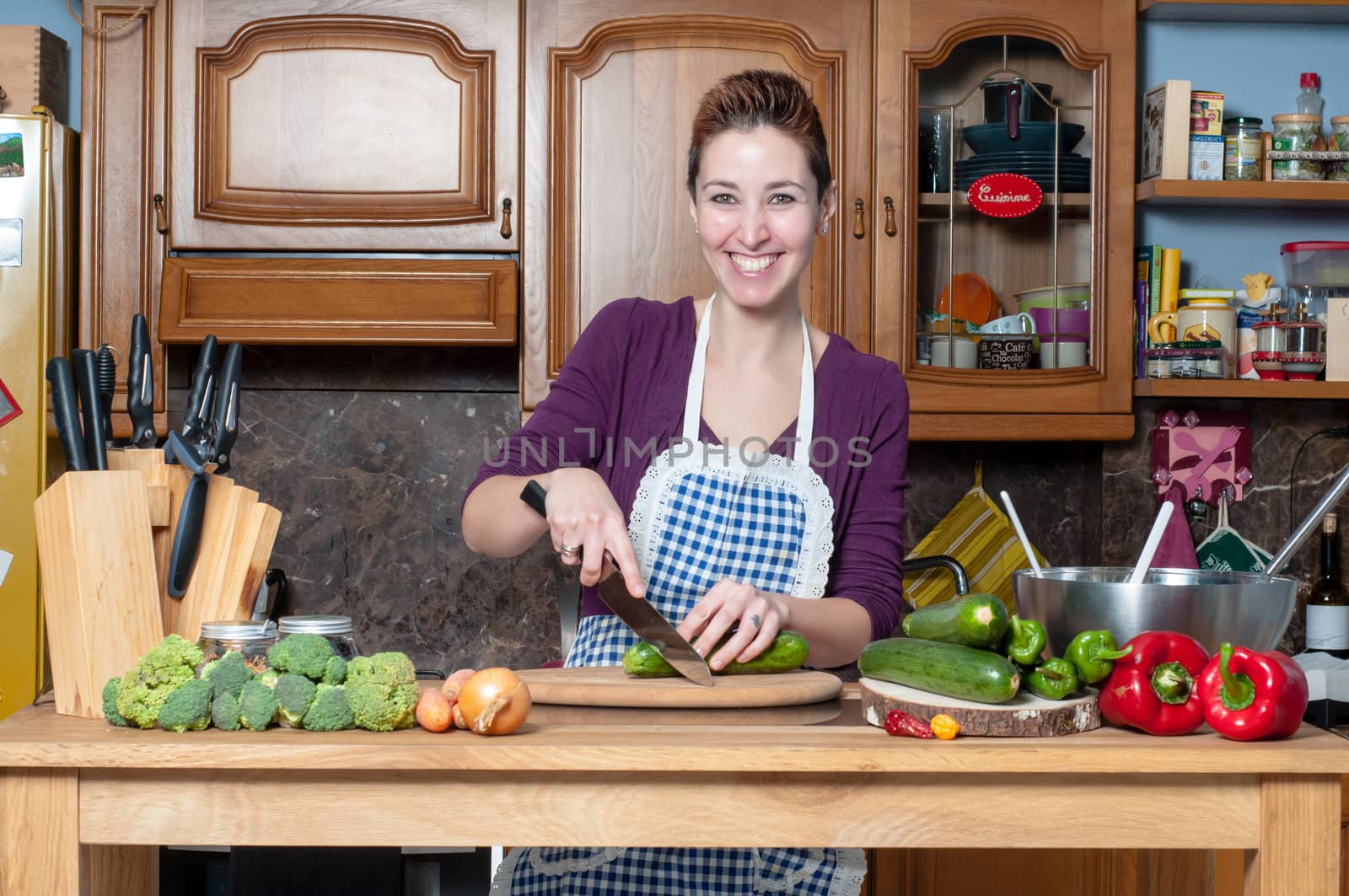 beautiful housewife cooking vegetables in the kitchen