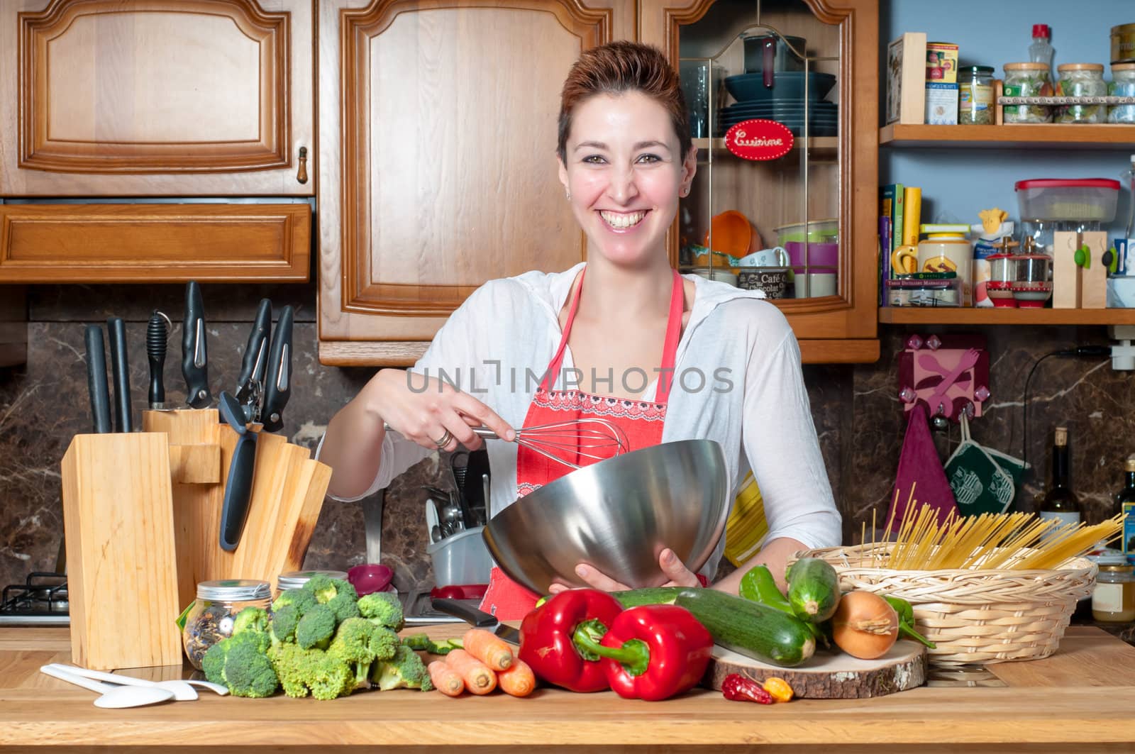 beautiful housewife cooking vegetables in the kitchen