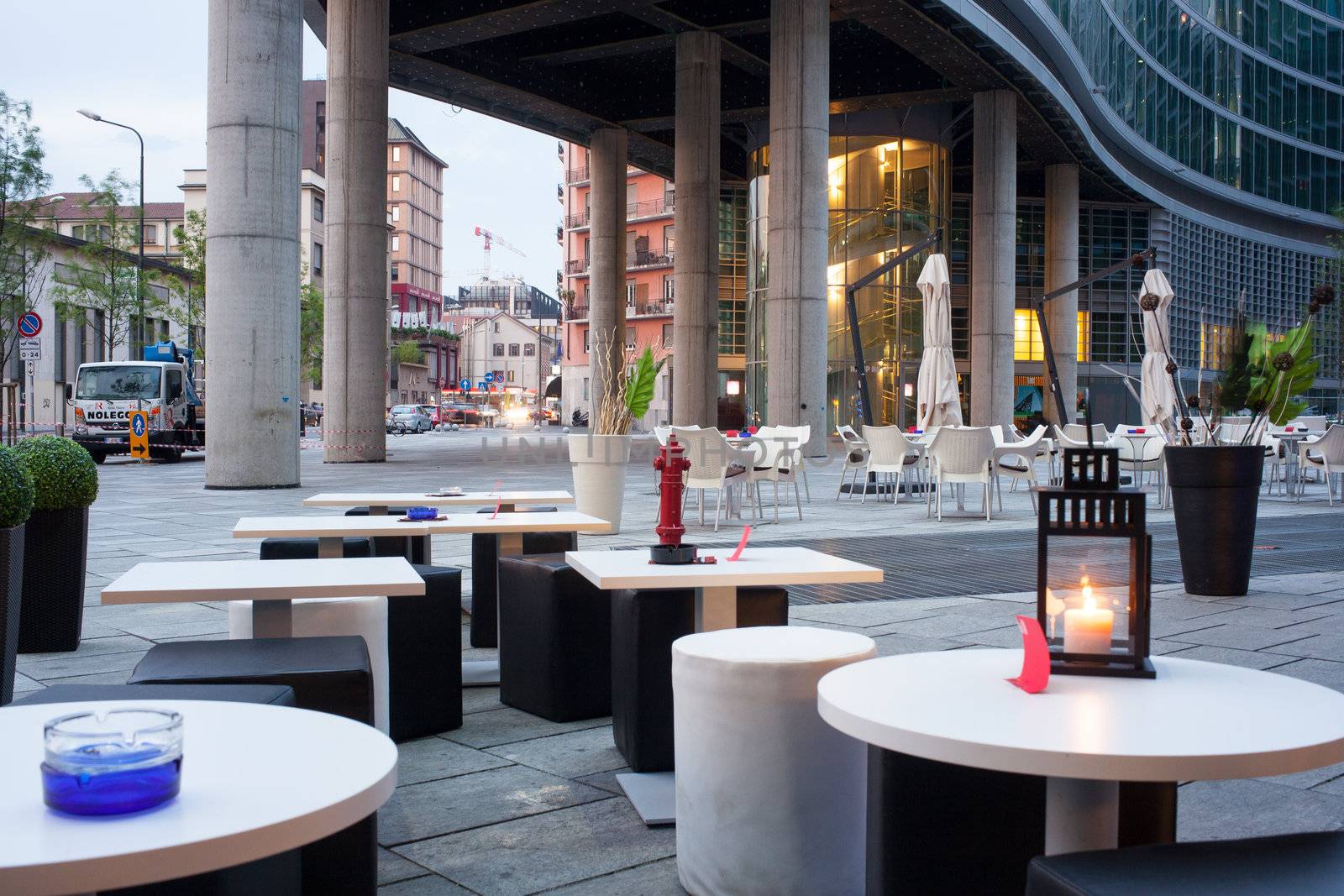 Little tables and stools in a outdoor pub