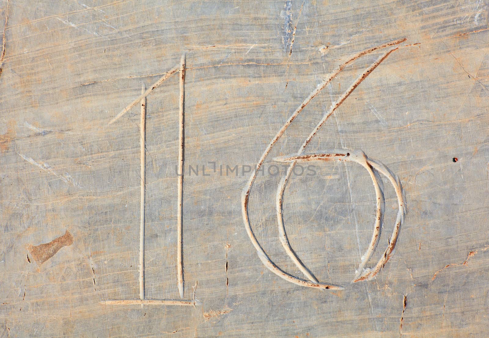 Photo of Numbers sixteen etched in stone