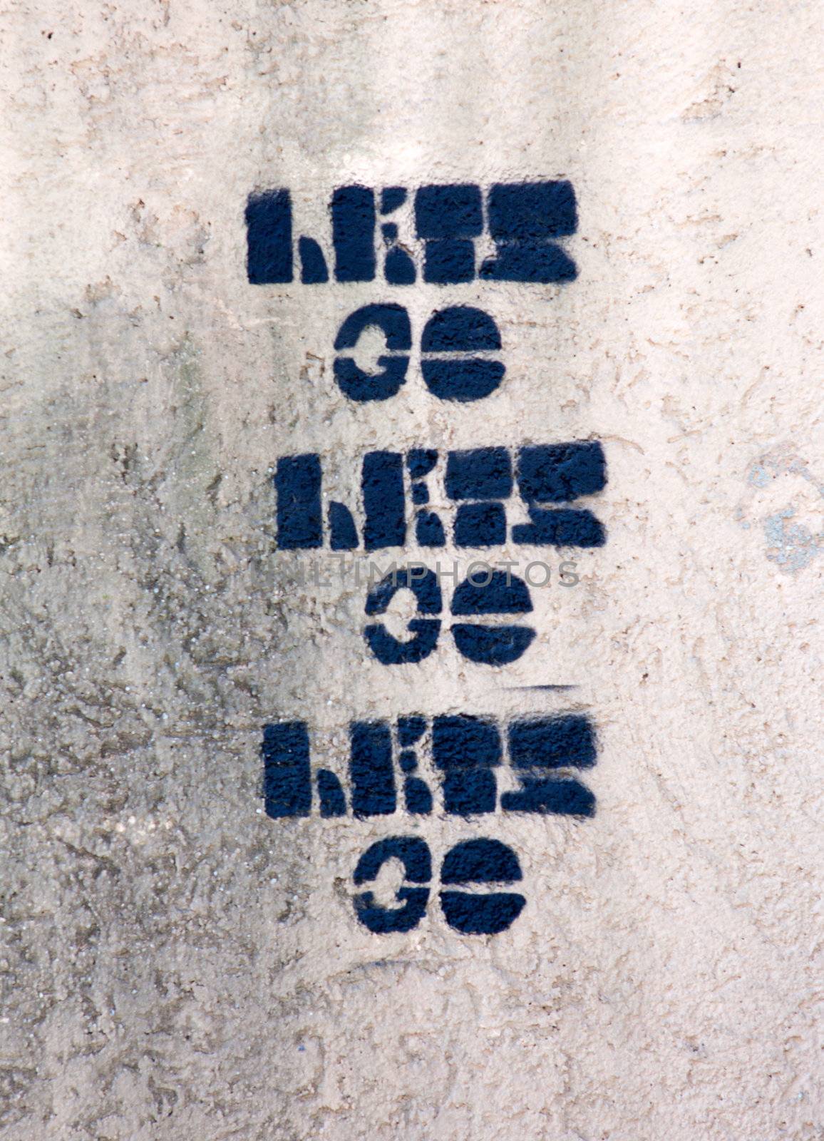 Phrase "lets go" painted on the street wall