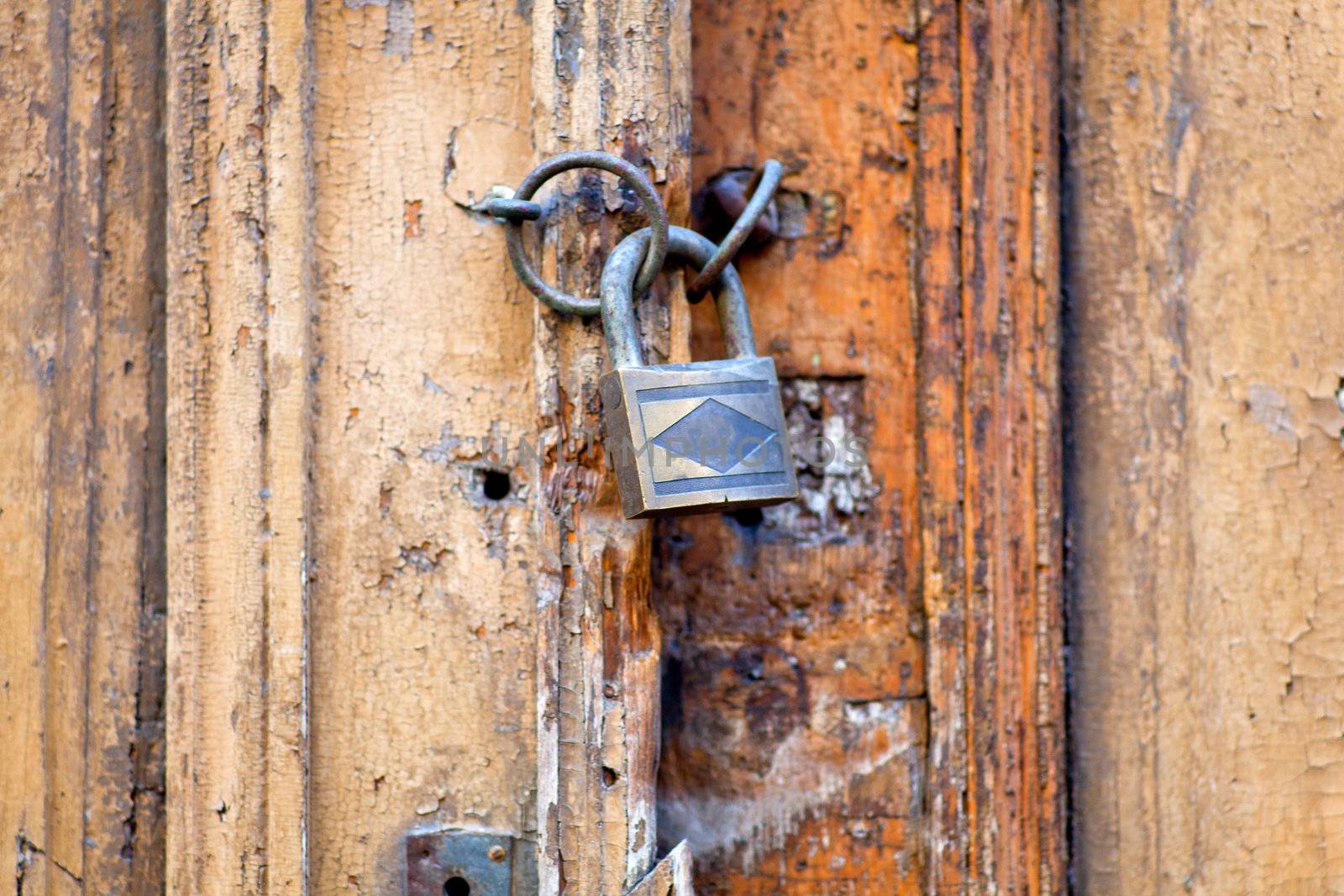 Photo of old wooden door closet with padlock