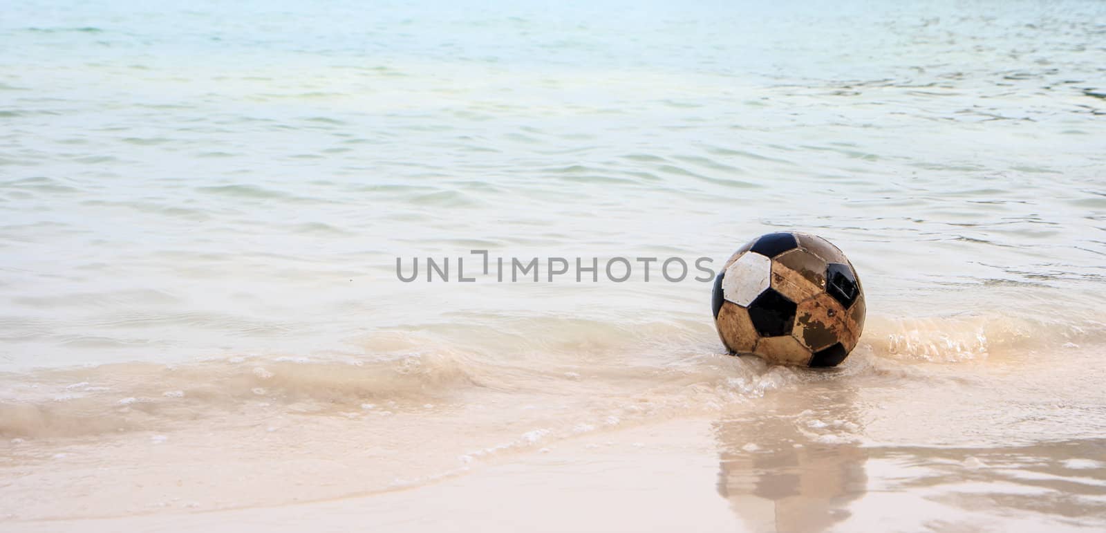 Old ball lonely on thebeach by bunwit