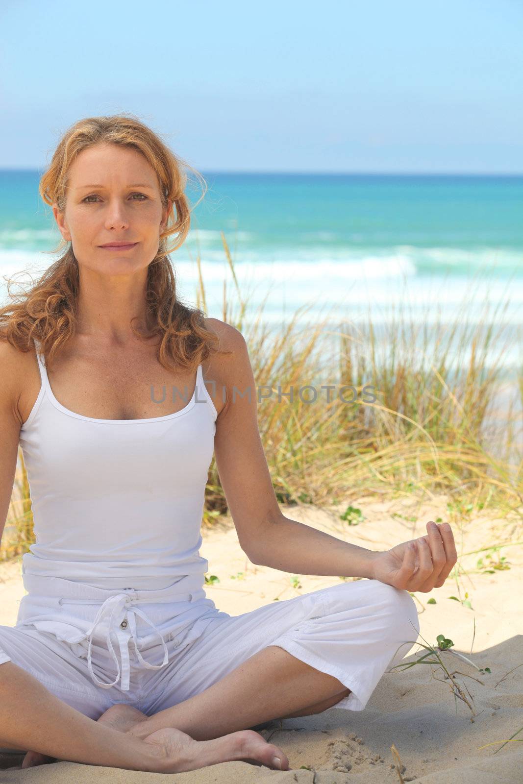 Woman doing yoga by phovoir