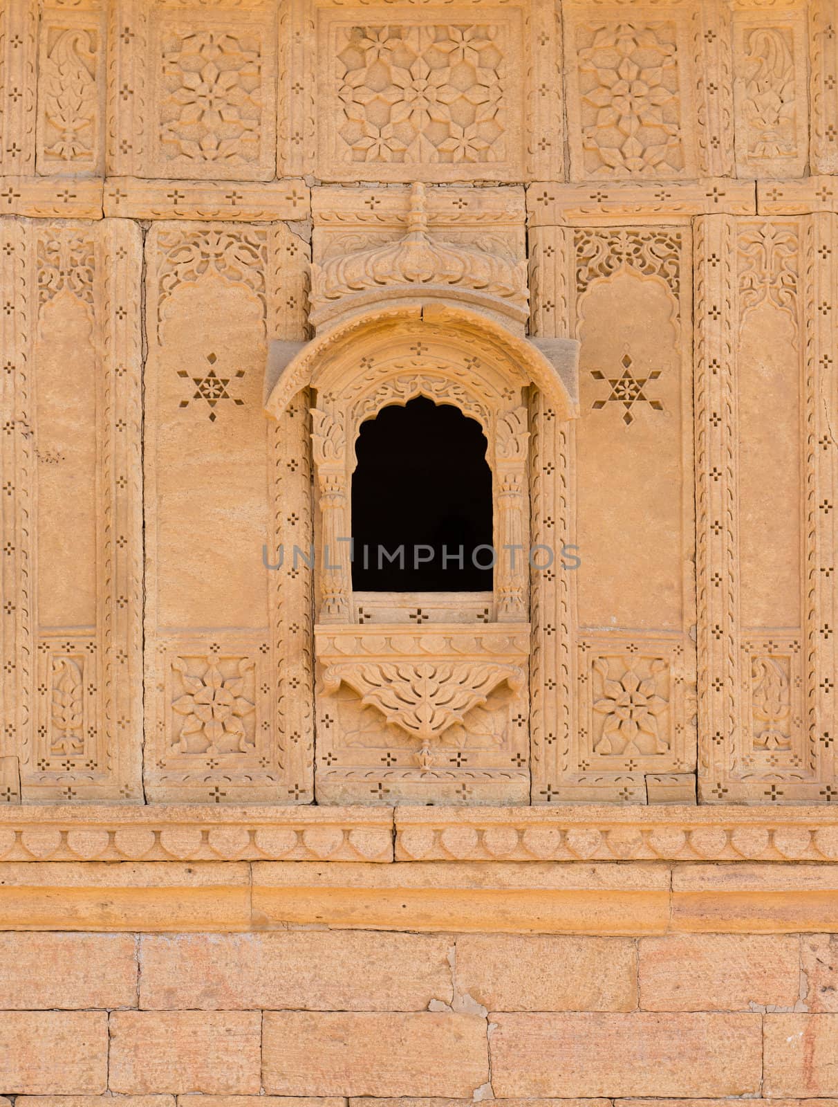 Small window with floral ornament on ruins of the royal cenotaphs of ancient Maharajas rulers in Bada Bagh, Jaisalmer, India