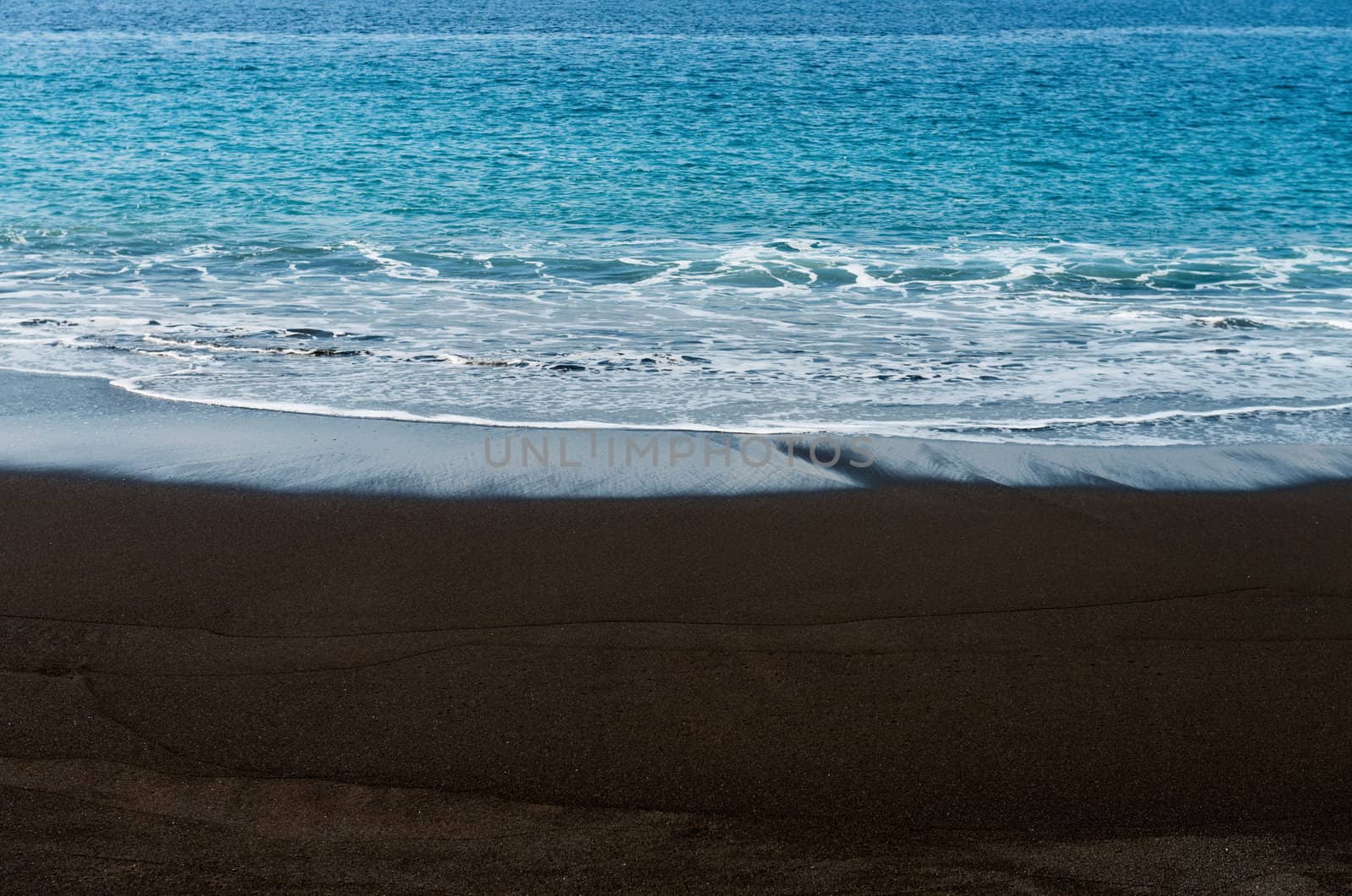 Black sand volcanic beach in Bali, Indonesia