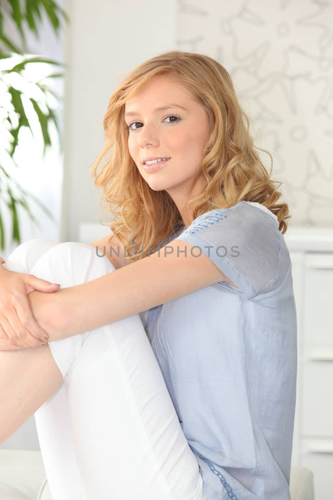 Young woman relaxed sitting on a couch