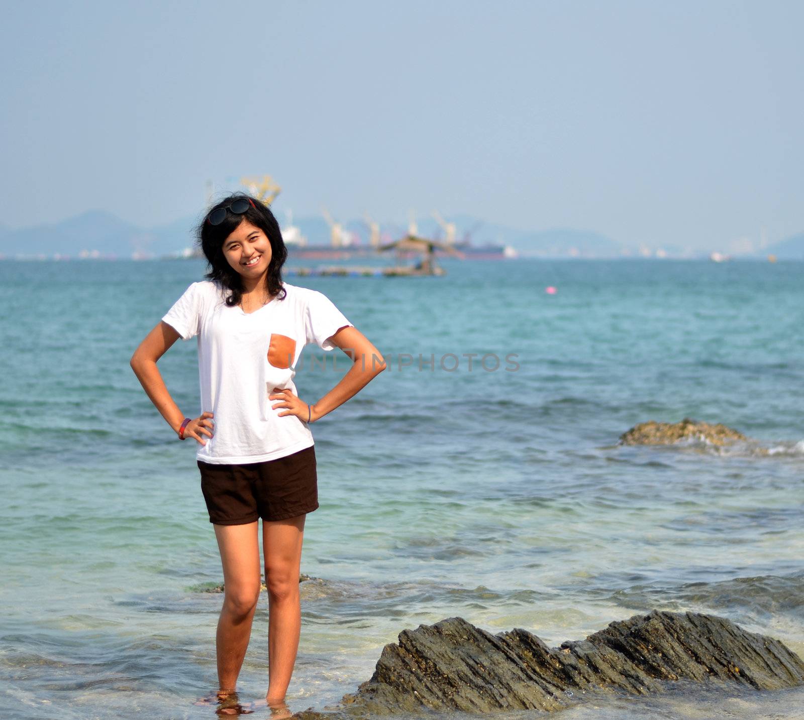 Beautiful young woman on beach by siraanamwong