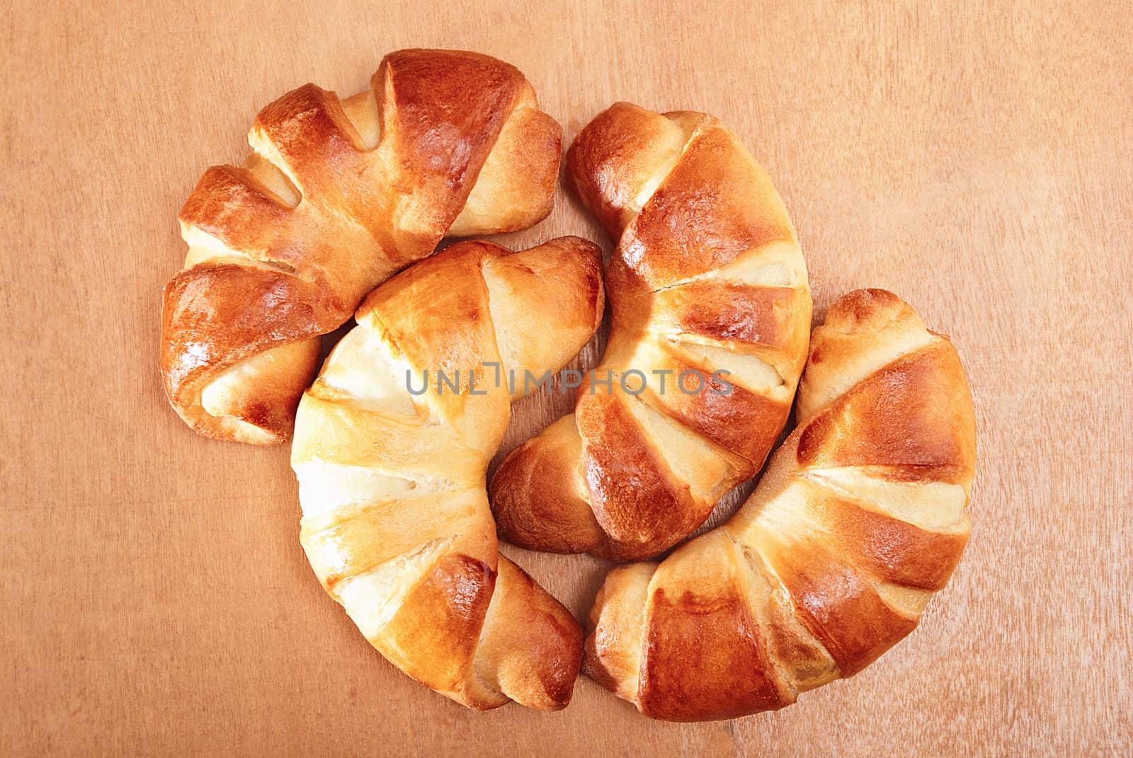 Freshly baked bagels on a wooden table.