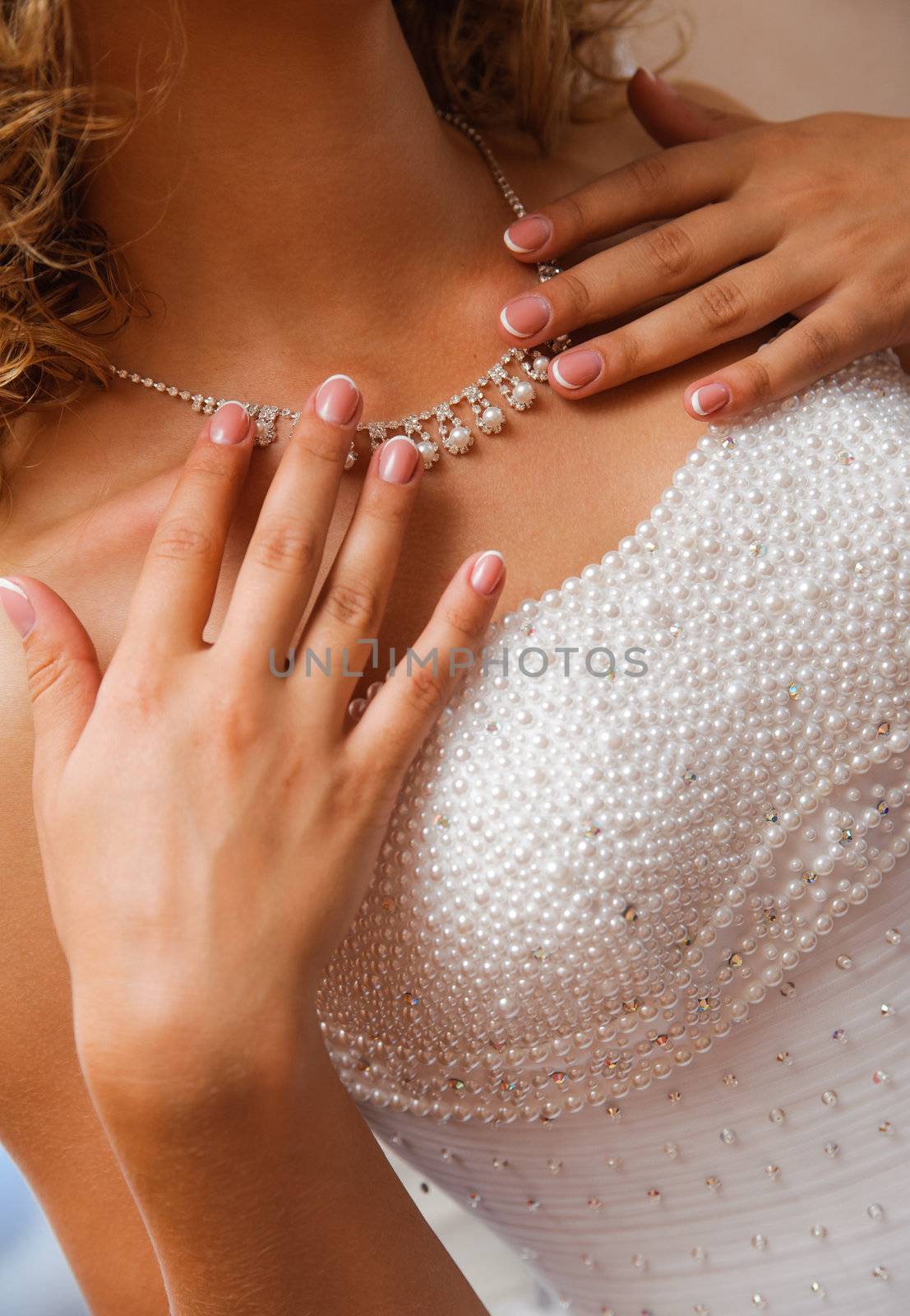  hands of bride touch to necklace. preparations time